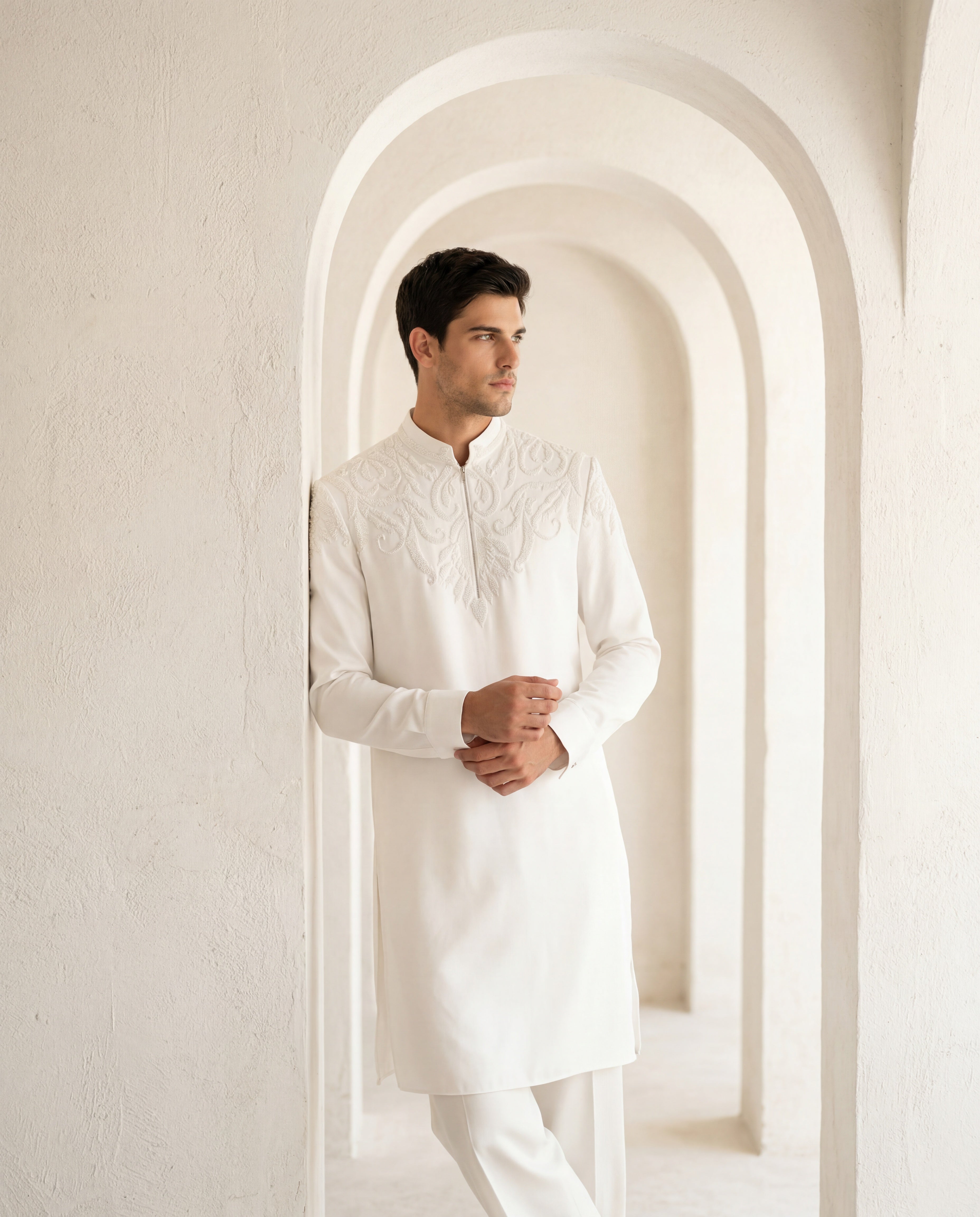 Ivory knit kurta with montone hand-embroidery around the neck-line, paired with matching knit palazzo.
