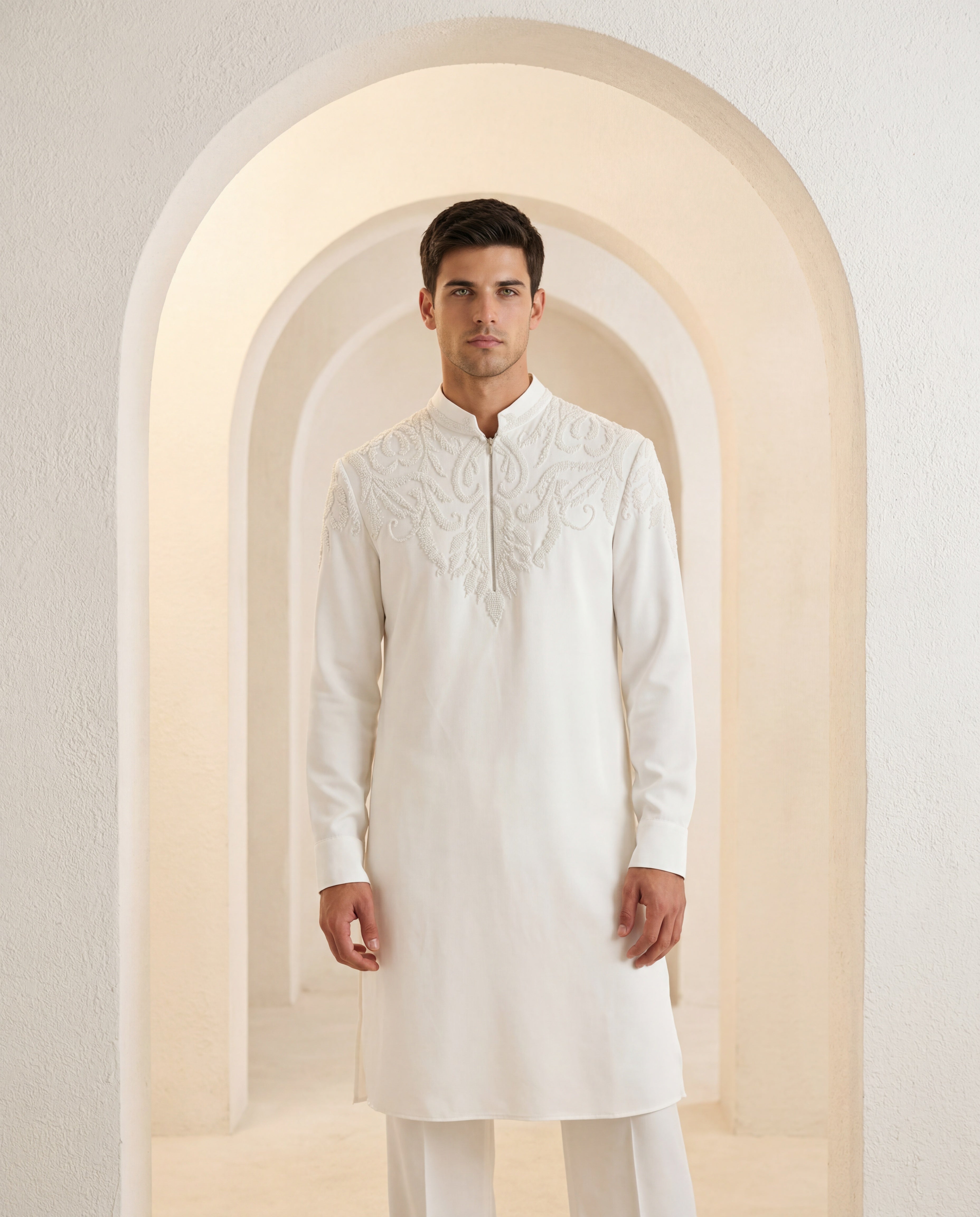Ivory knit kurta with montone hand-embroidery around the neck-line, paired with matching knit palazzo.