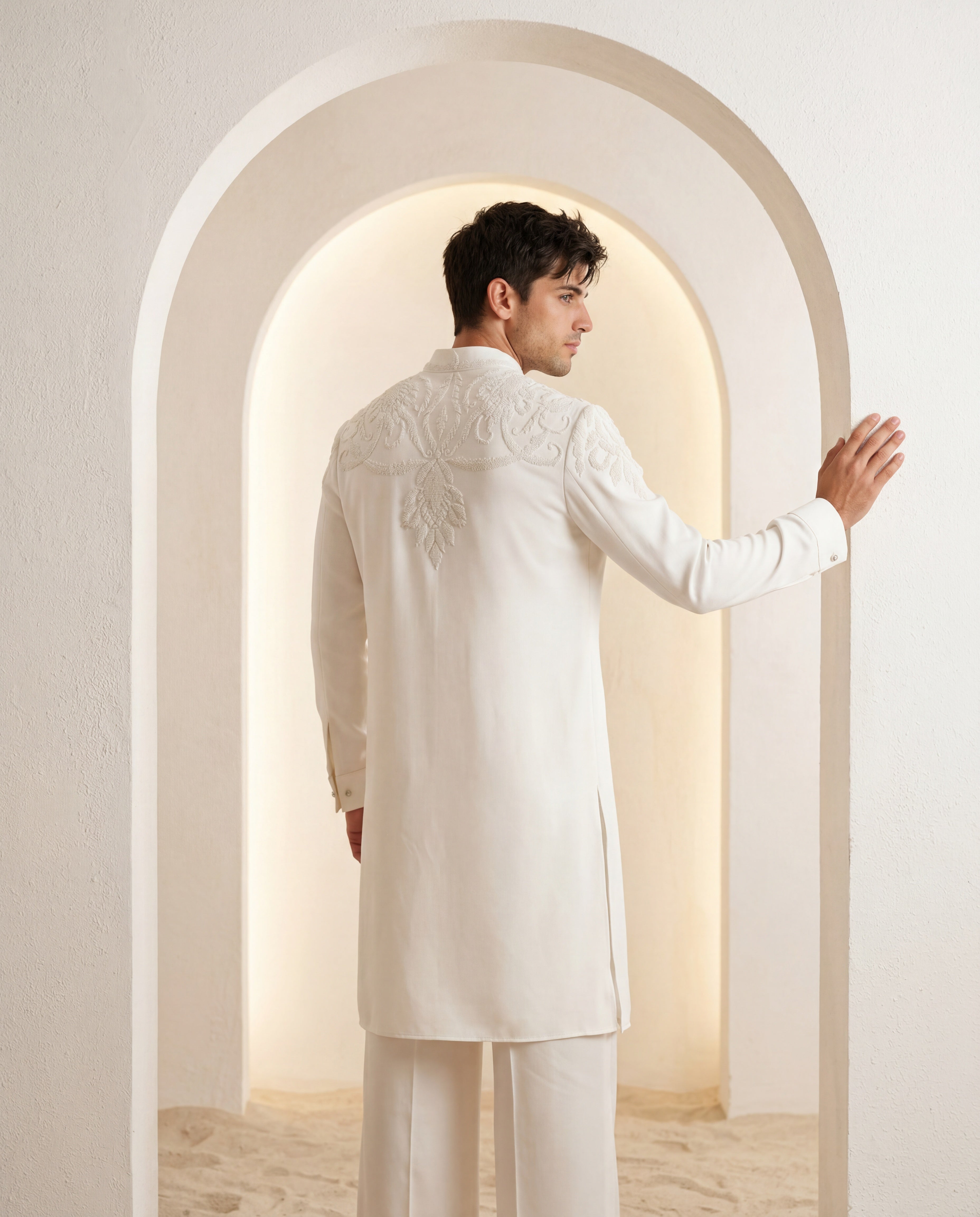 Ivory knit kurta with montone hand-embroidery around the neck-line, paired with matching knit palazzo.