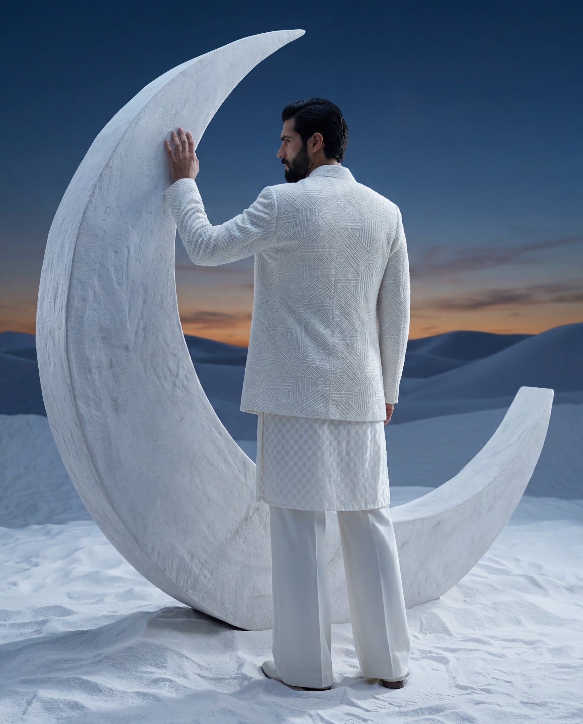 Ivory silk Indo-Western jacket with monotone geometrical embroidery, paired with an embroidered Chanderi kurta and knit pants.