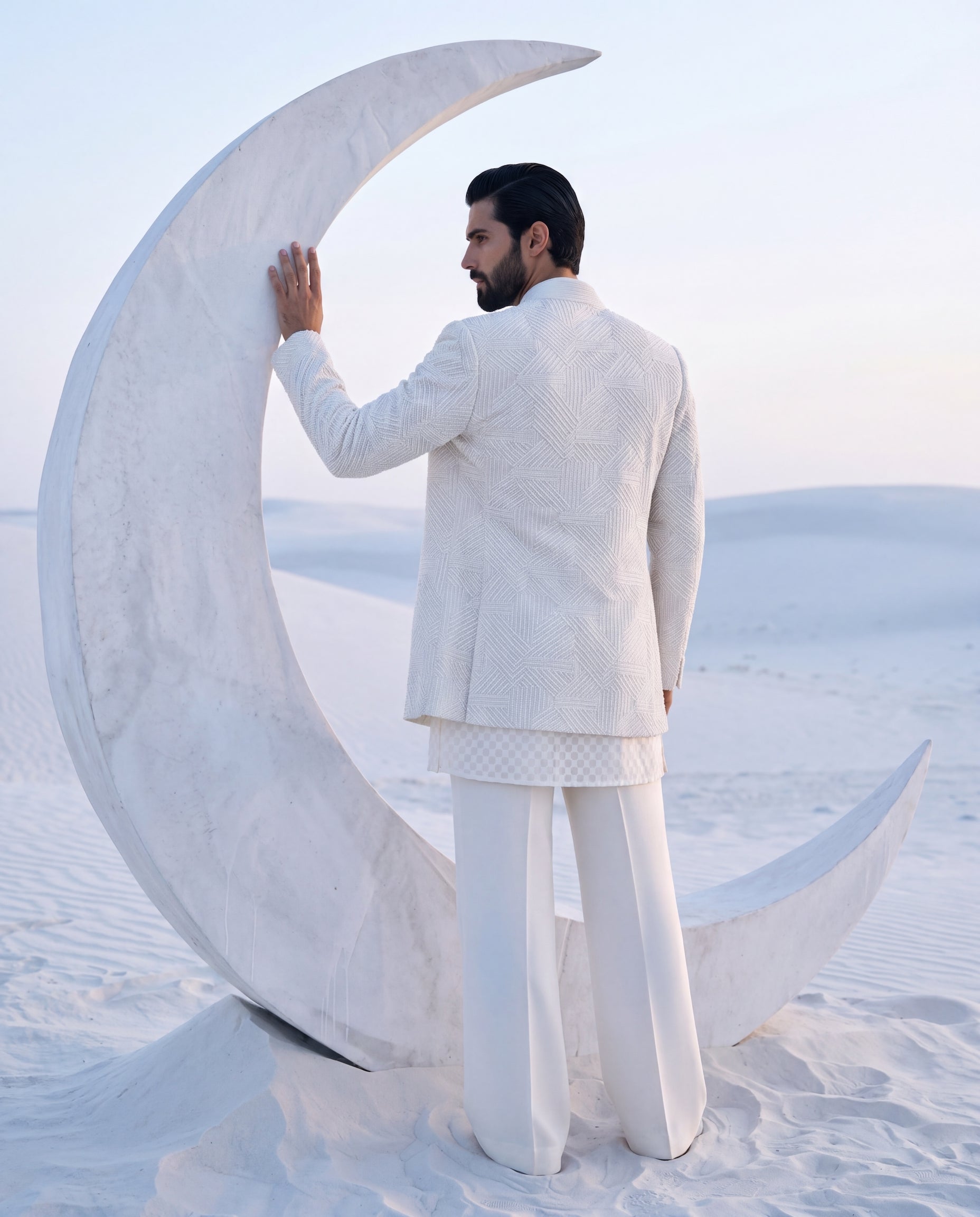 Ivory silk Indo-Western jacket with monotone geometrical embroidery, paired with an embroidered Chanderi kurta and knit pants.