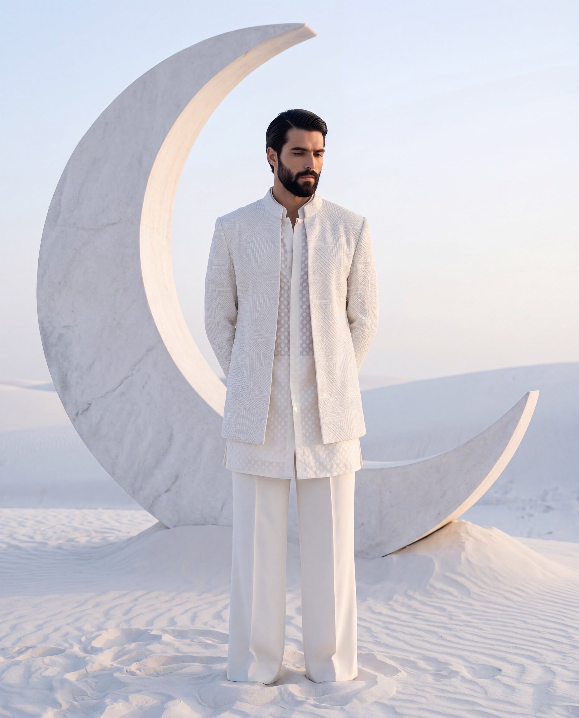 Ivory silk Indo-Western jacket with monotone geometrical embroidery, paired with an embroidered Chanderi kurta and knit pants.