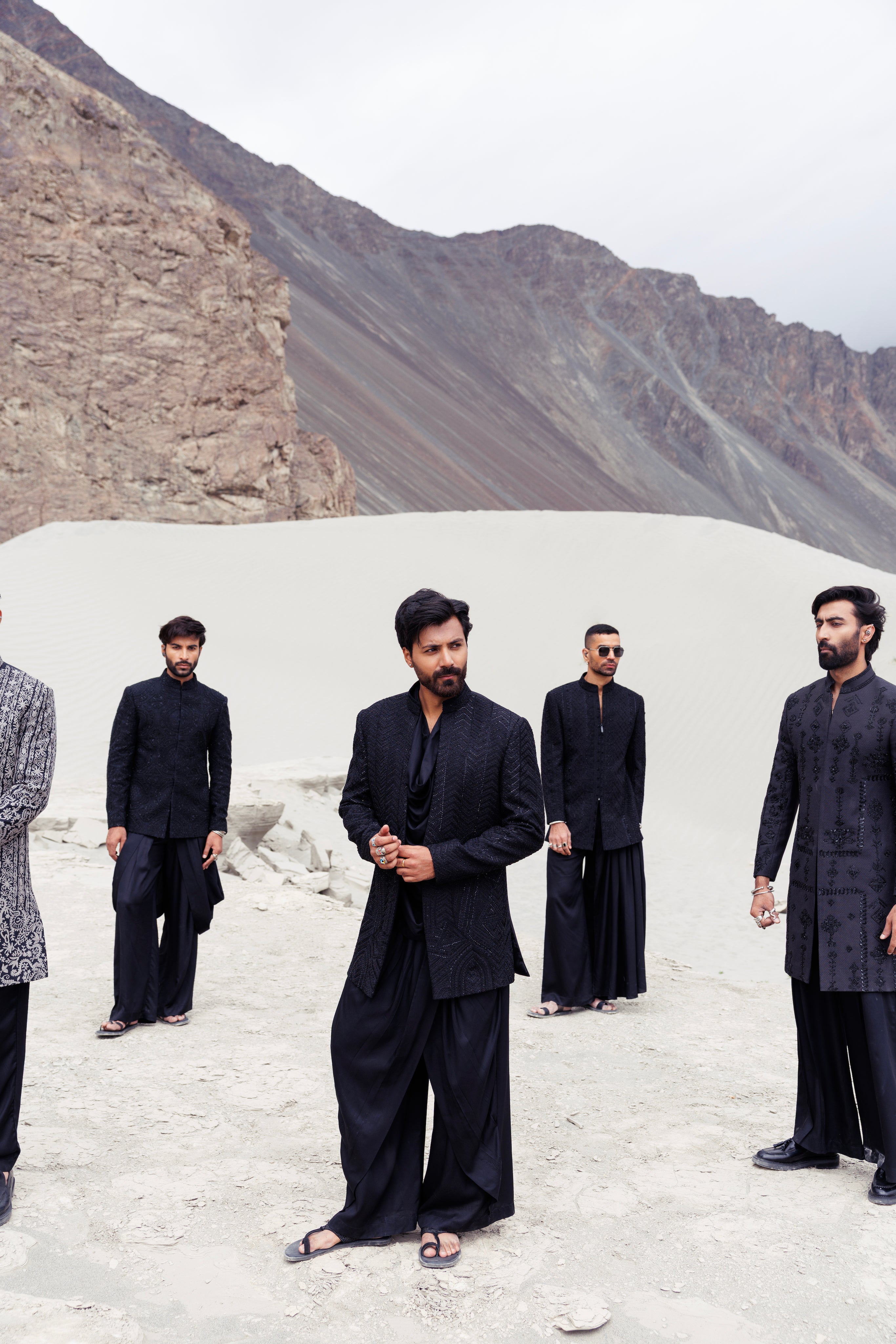 Black open hand-embroidered indowestern jacket paired with a short cowl neck kurta and a dhoti style plazo.