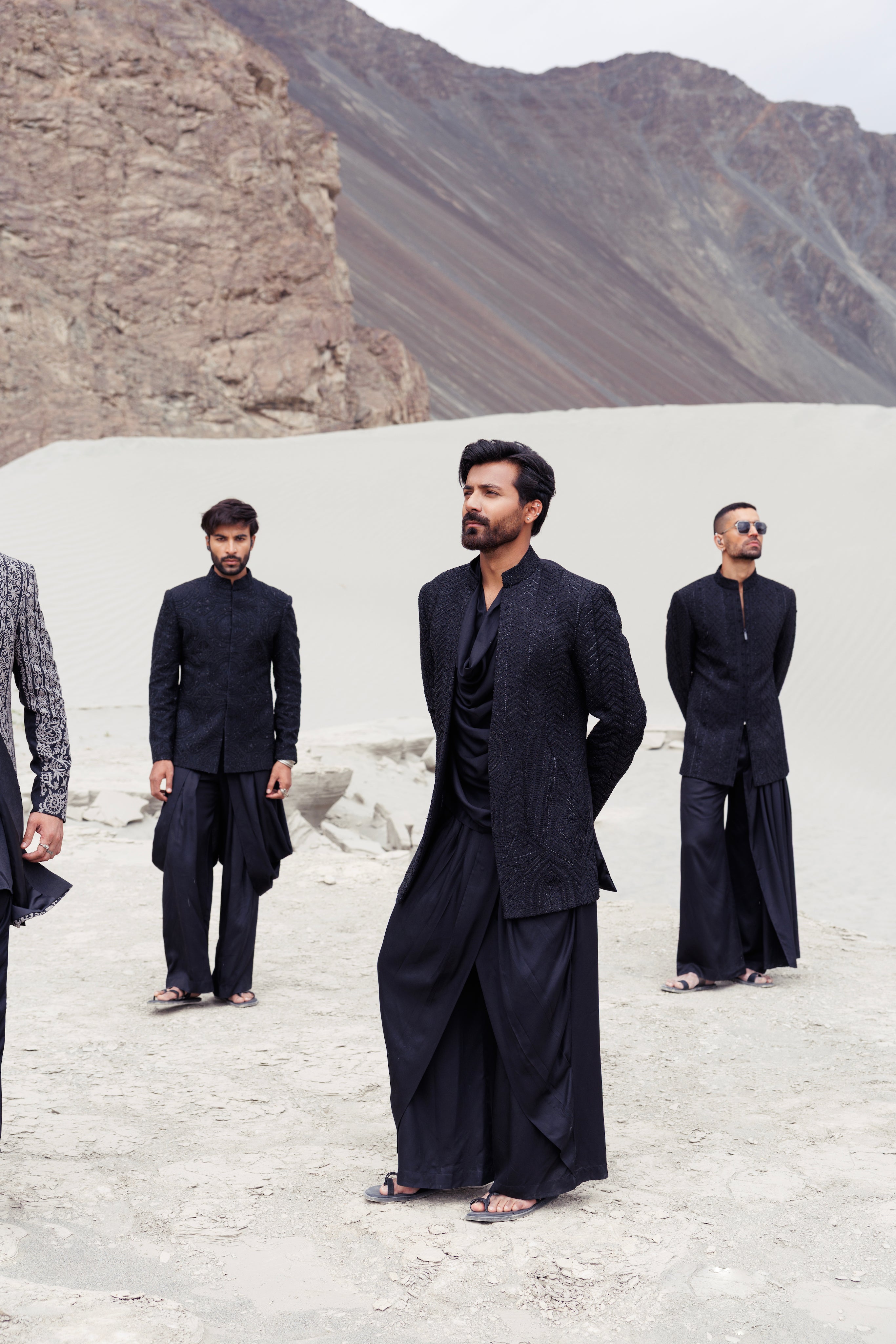 Black open hand-embroidered indowestern jacket paired with a short cowl neck kurta and a dhoti style plazo.