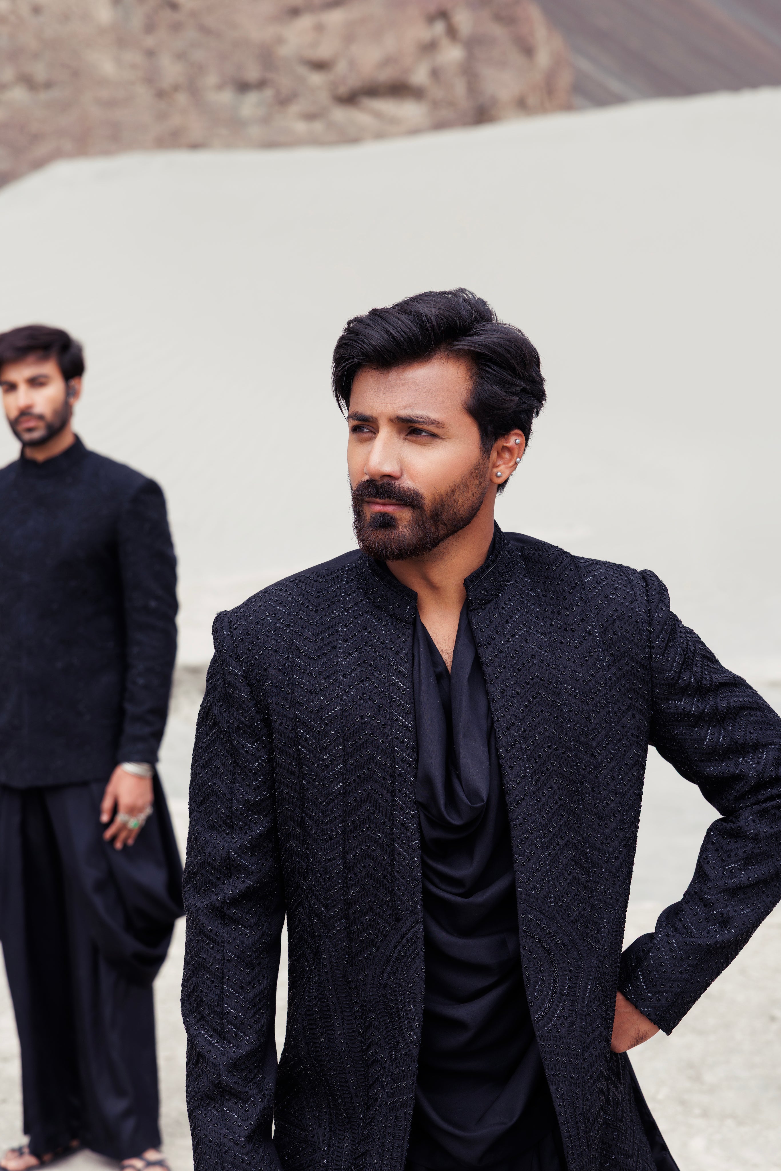 Black open hand-embroidered indowestern jacket paired with a short cowl neck kurta and a dhoti style plazo.
