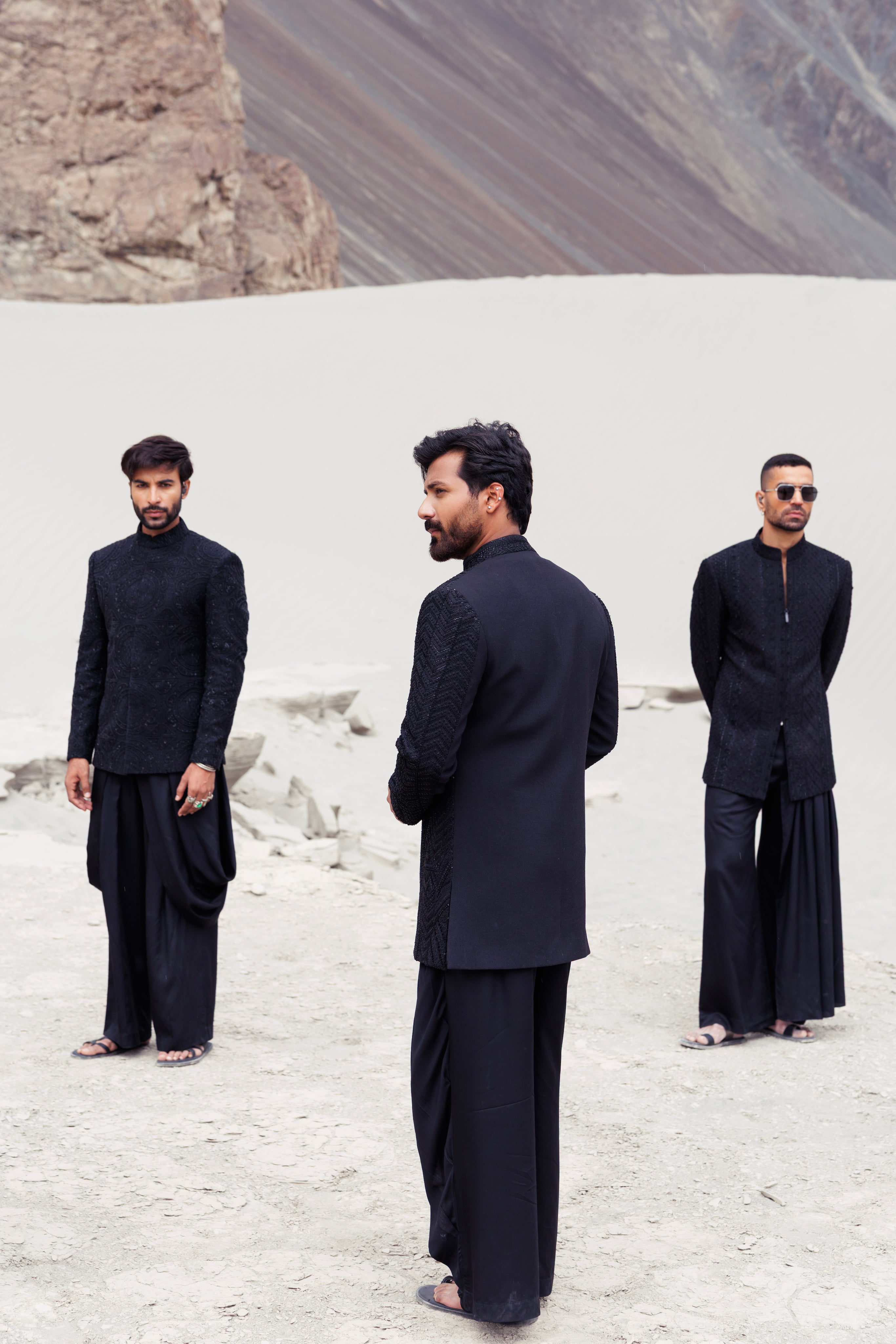 Black open hand-embroidered indowestern jacket paired with a short cowl neck kurta and a dhoti style plazo.
