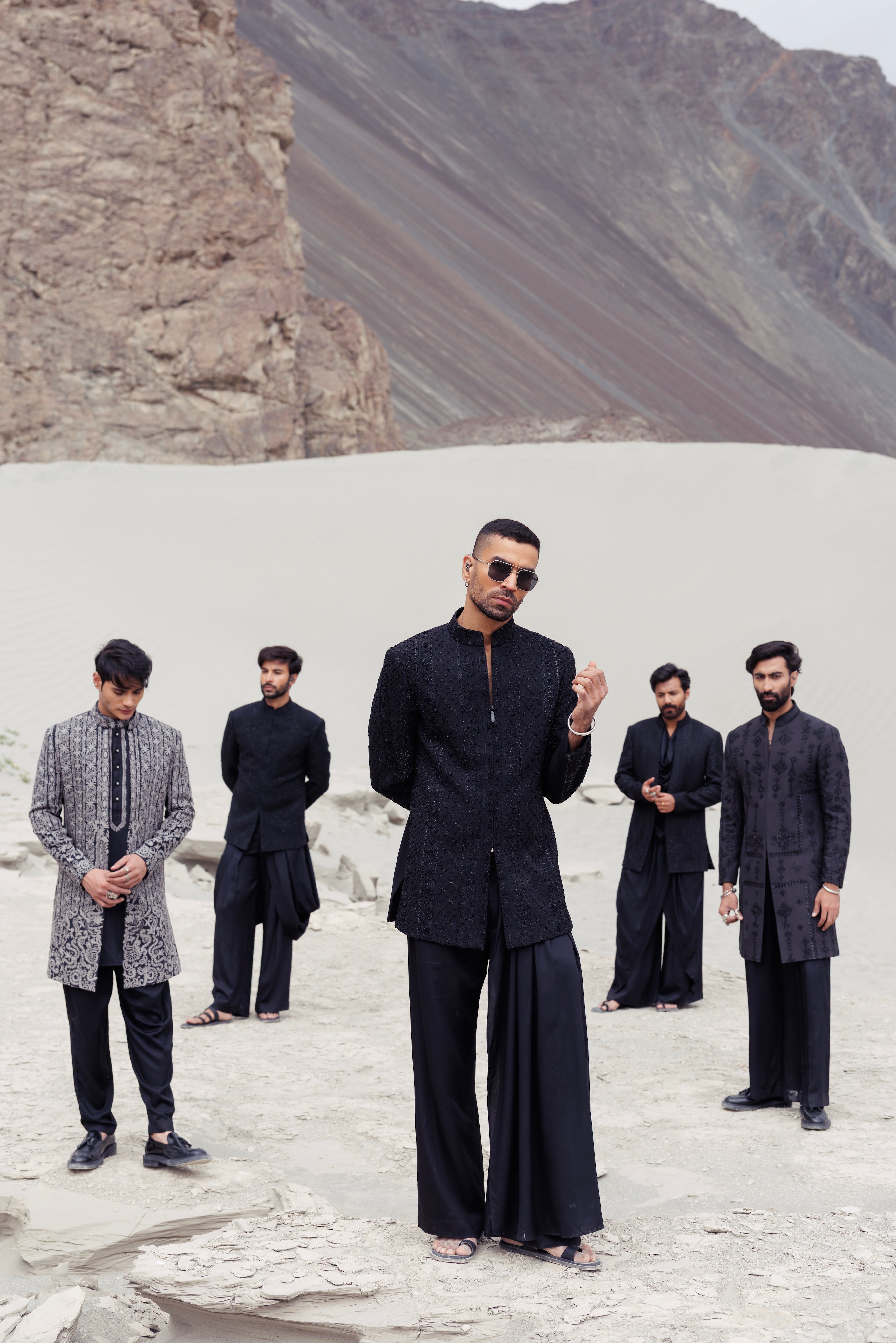 Black short indowestern jacket with front zipper and monotone hand-embroidery paired with a dhoti style plazo.