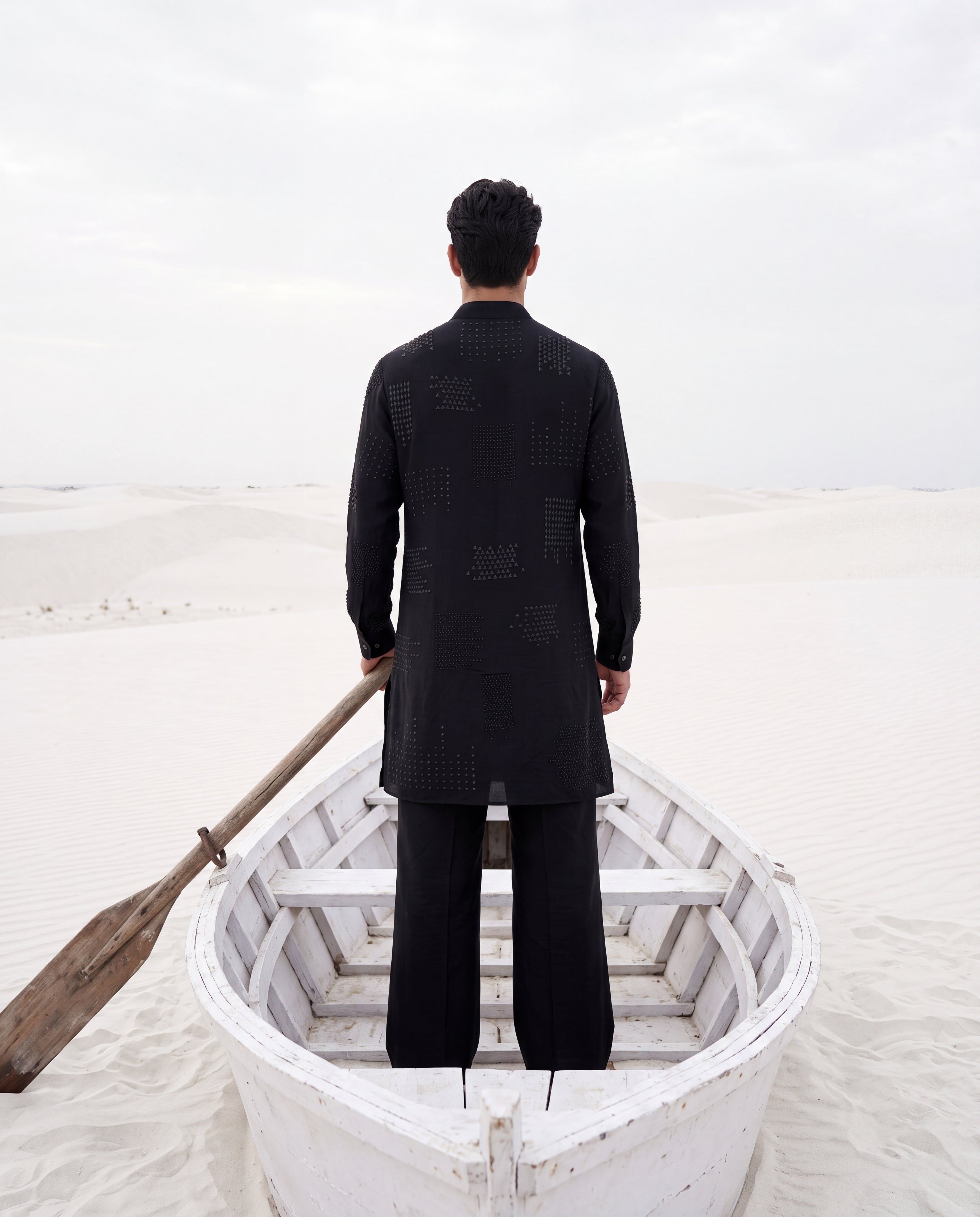 Black knit kurta with tonal embroidered detailing, paired with matching knit palazzo.
