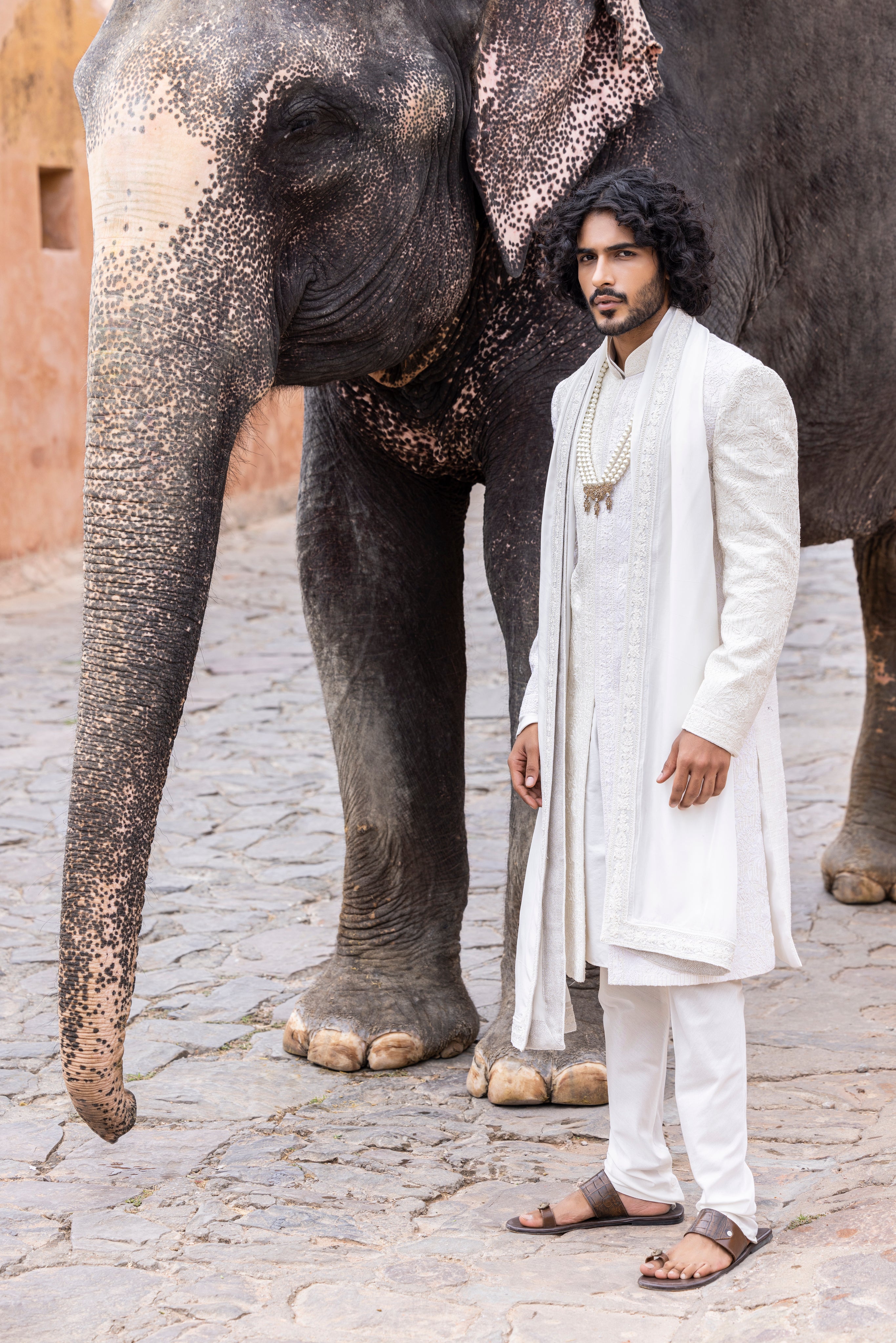 Hand embroidered sherwani paired with matching kurta, pyjama & stole.