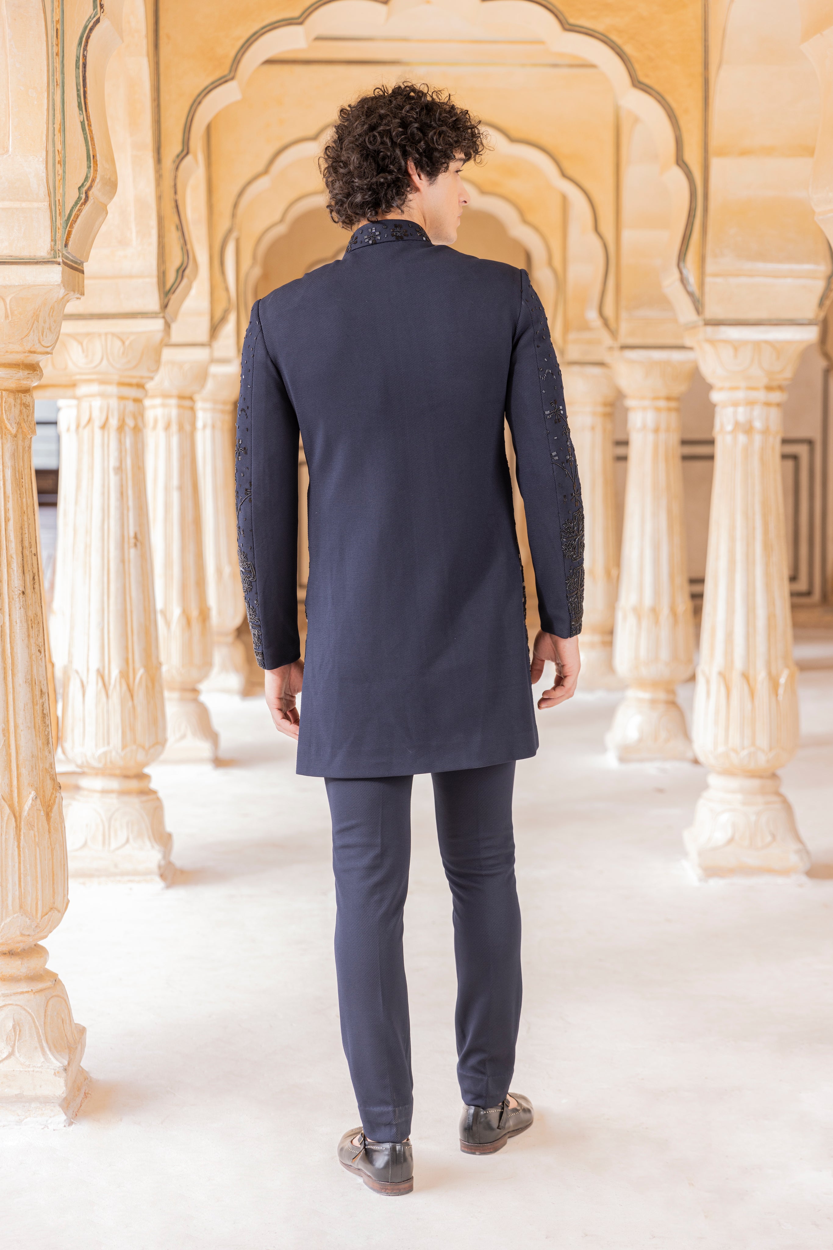 Long Navy Blue indowestern jacket highlighted with cut daana hand embroidery paired with pants.