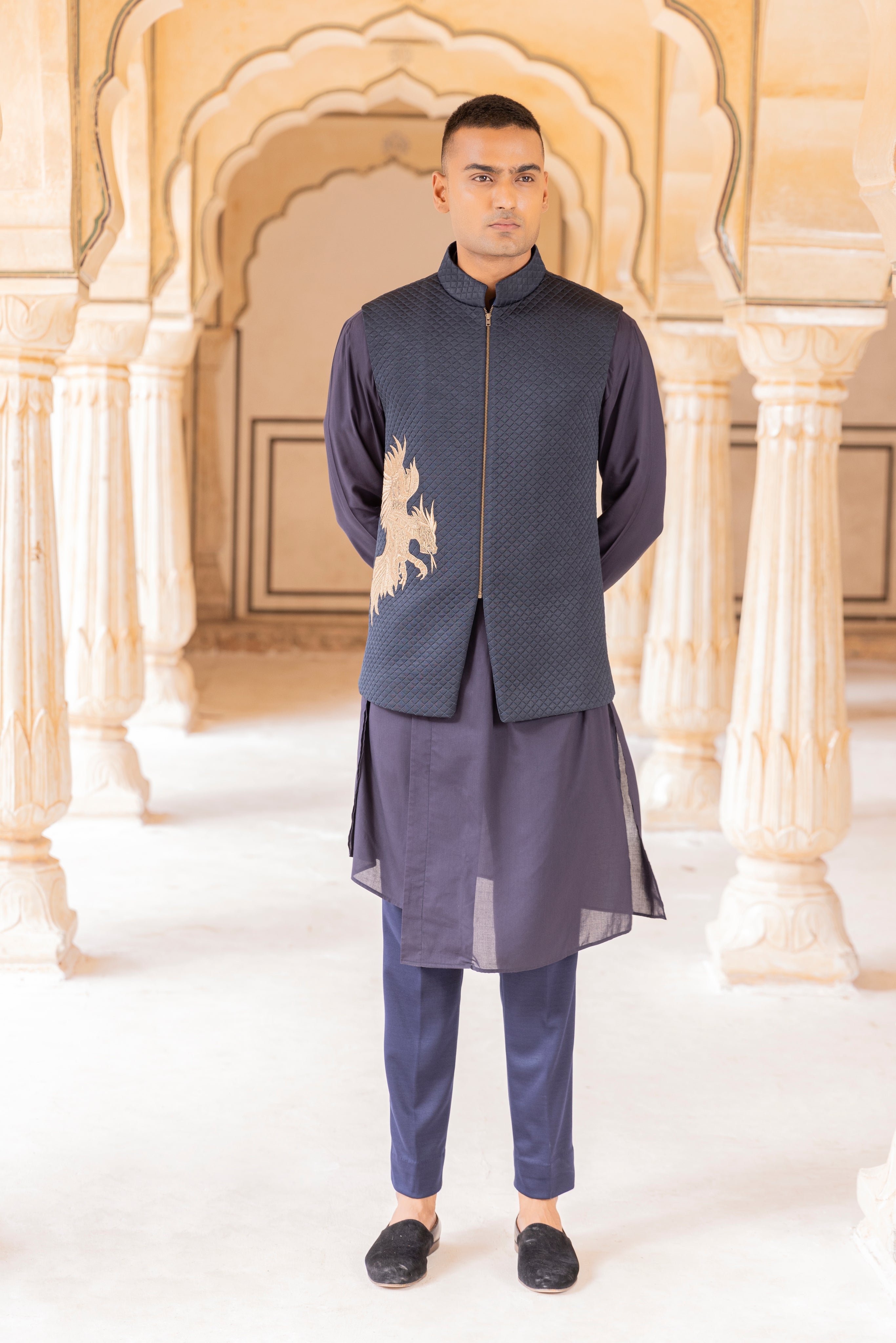 Quilted waistcoat embellished with Dragon motif using zari embroidery paired with kurta and aligadhi.