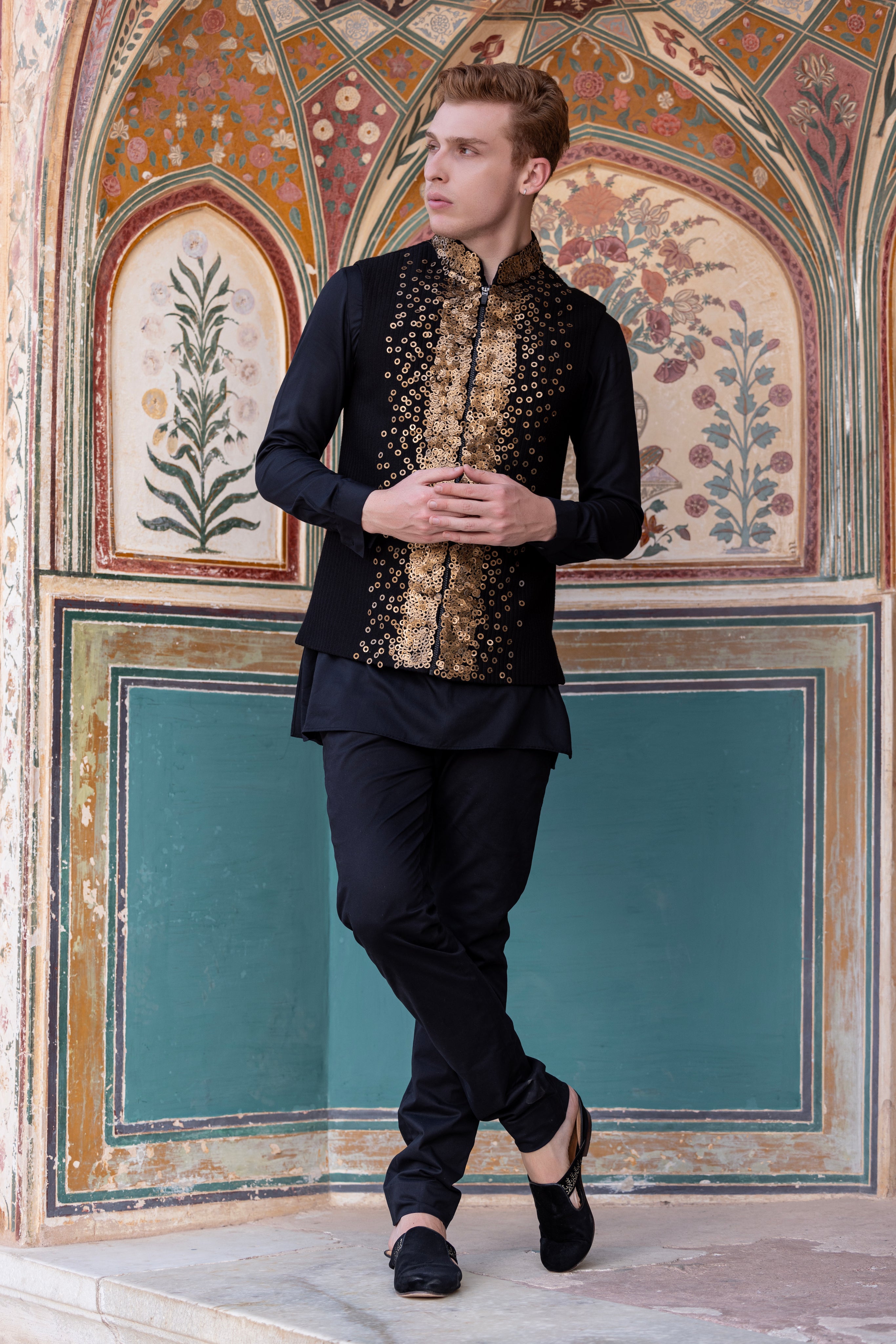Hand embroidered sequins waistciat paired with kurta and aligadhi.