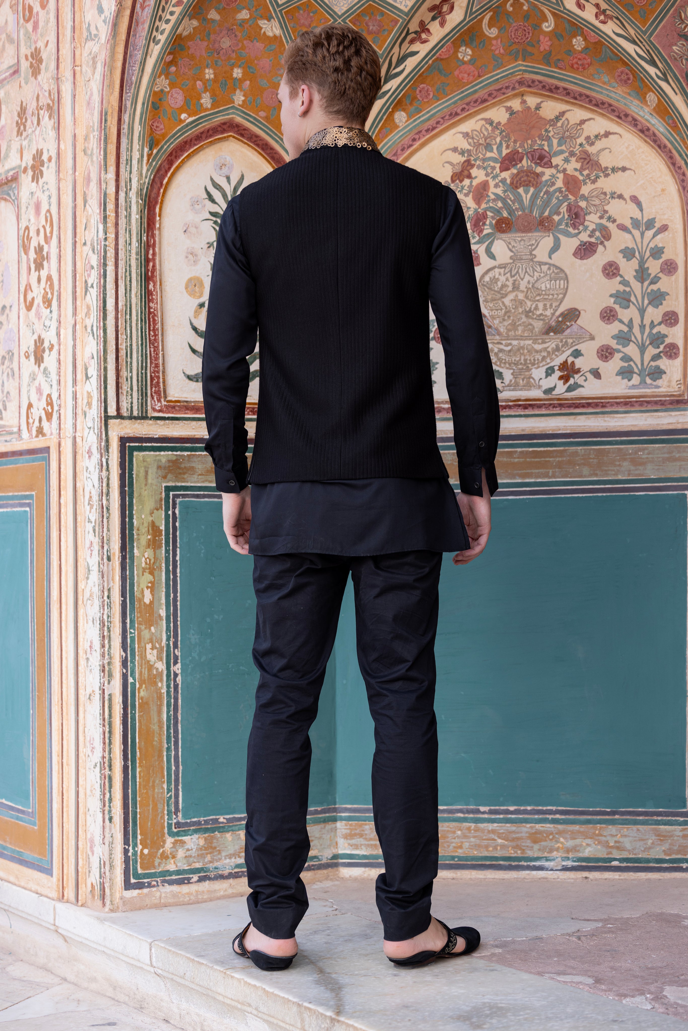 Hand embroidered sequins waistciat paired with kurta and aligadhi.