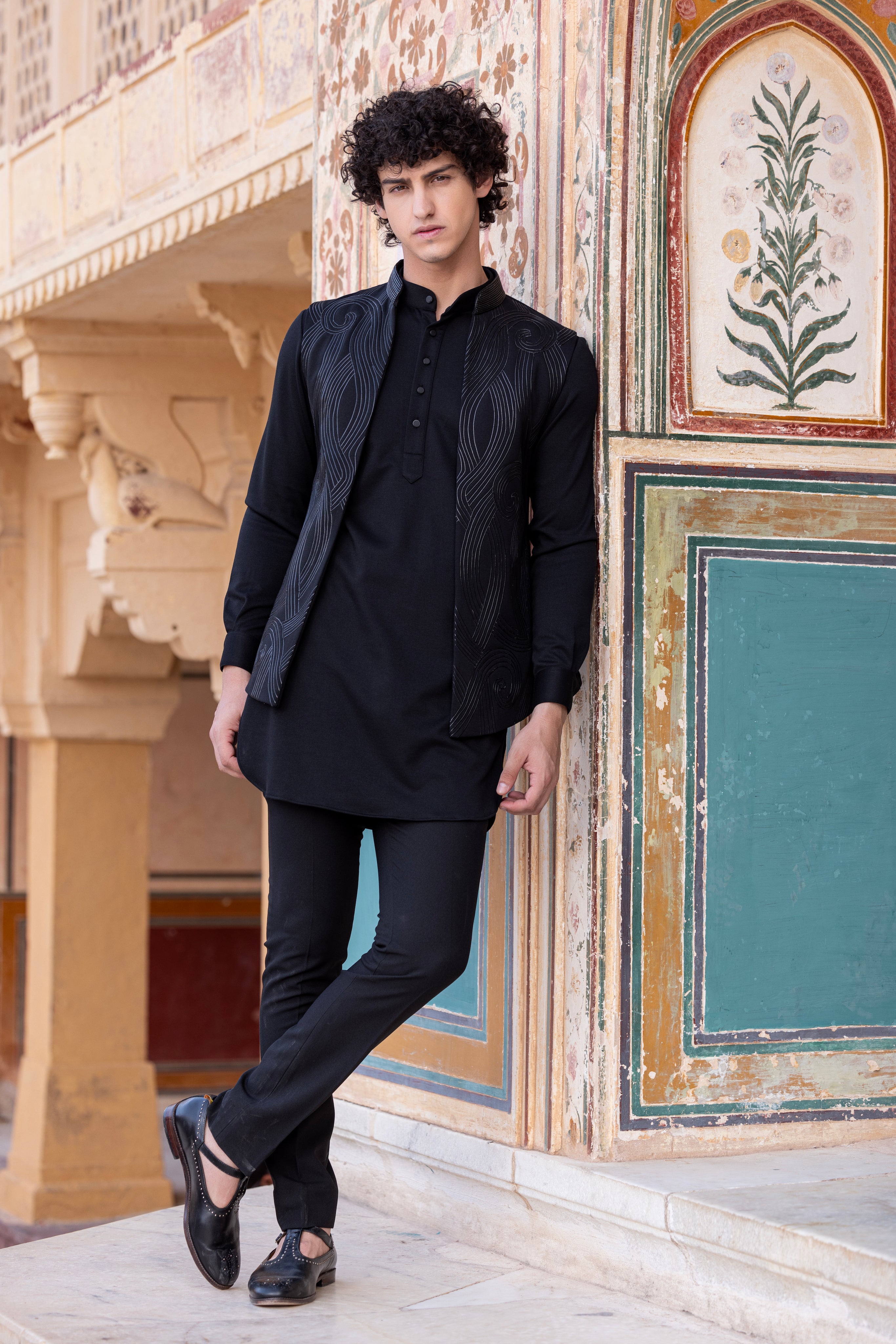Leather work waistcoat paired with kurta and pant.