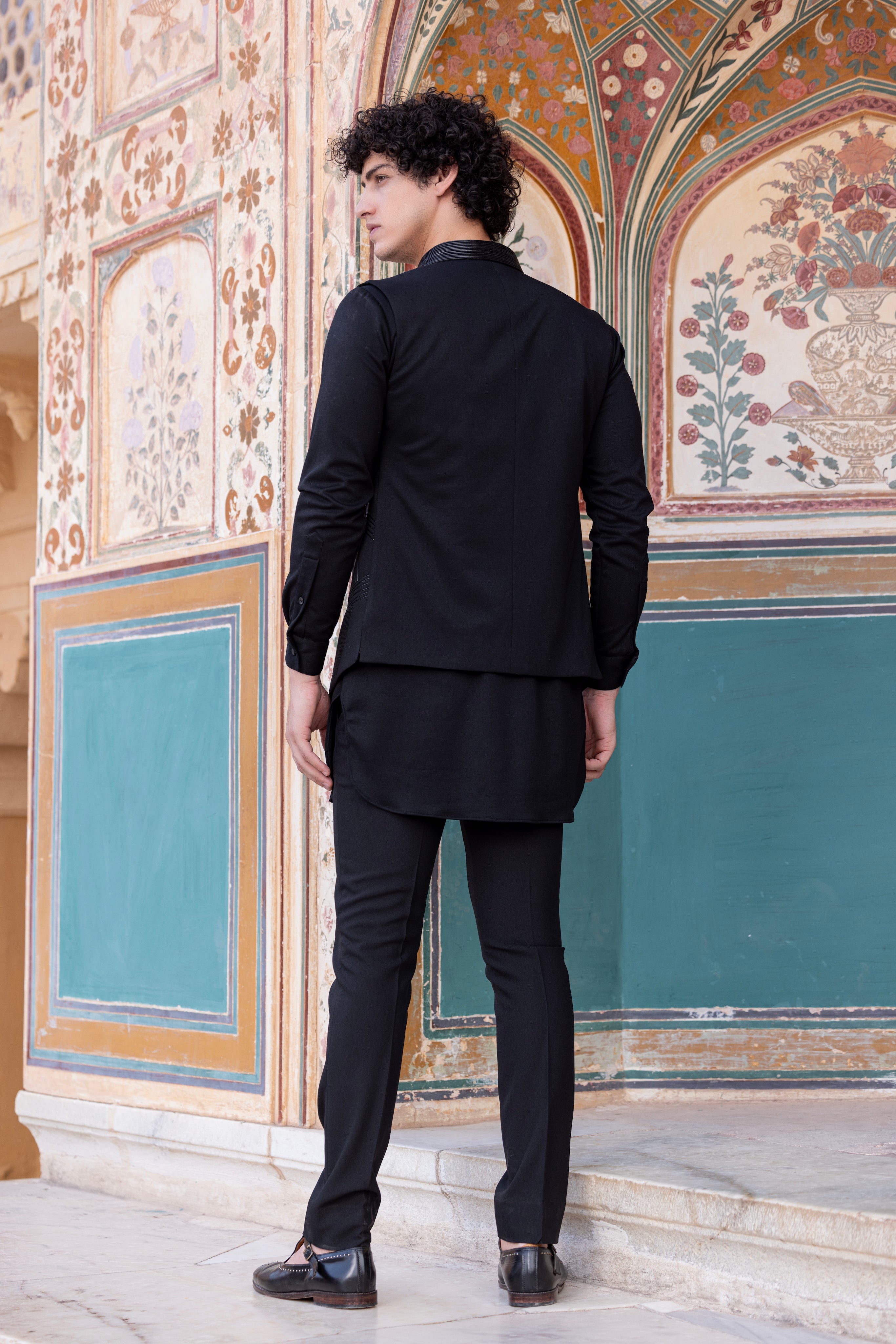 Leather work waistcoat paired with kurta and pant.