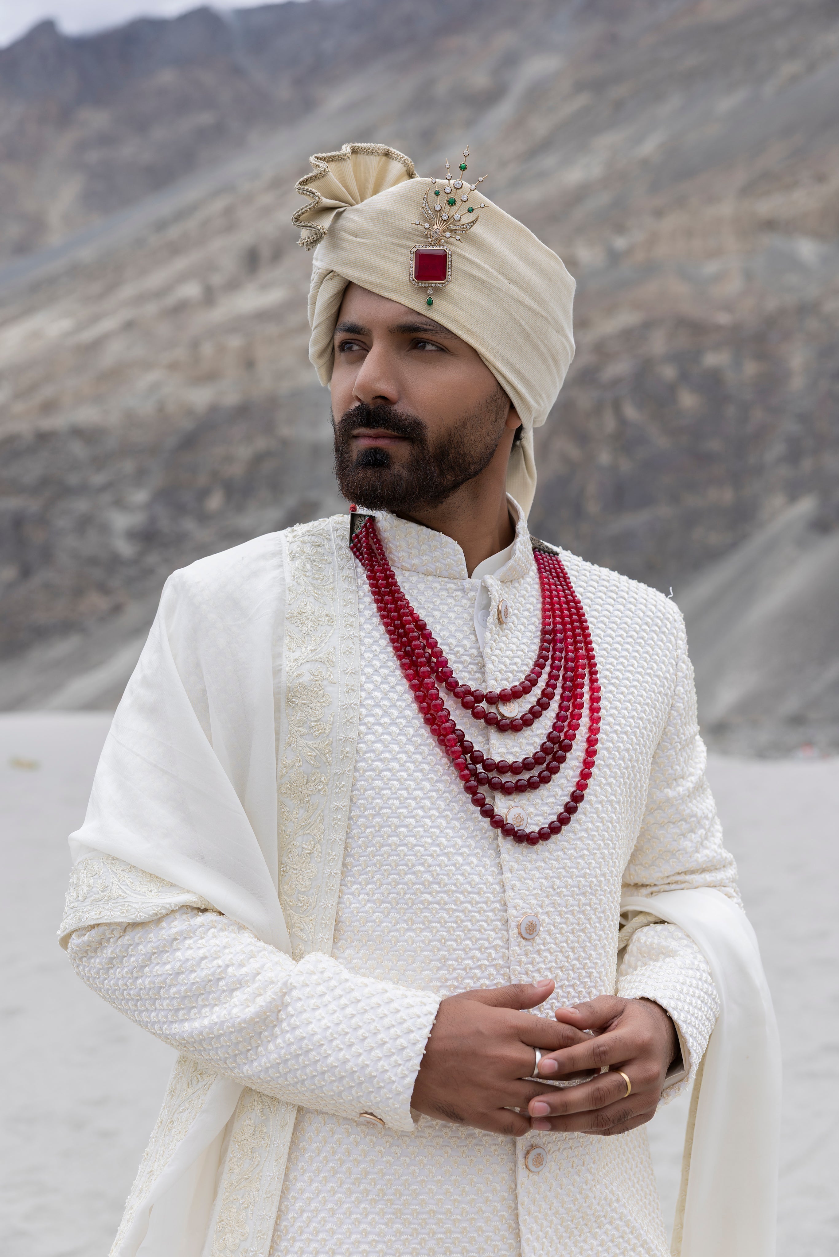Ivory poly crepe sherwani with intricate hand-embroidery paired with a modal kurta pyjama & an organza stole.
