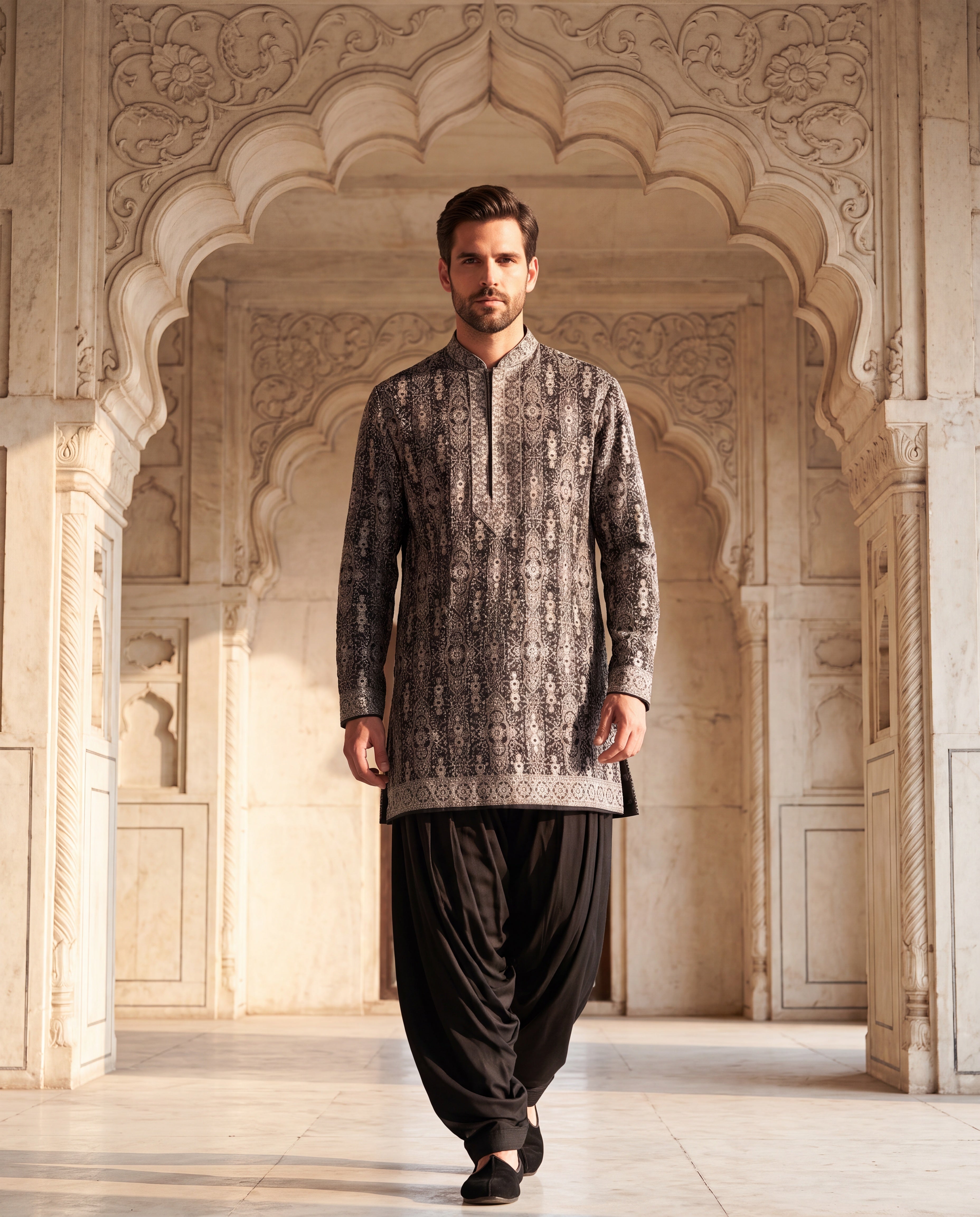 Black silk kurta with multi-coloured intricate embroidered detailing, paired with matching cotton modal salwar.