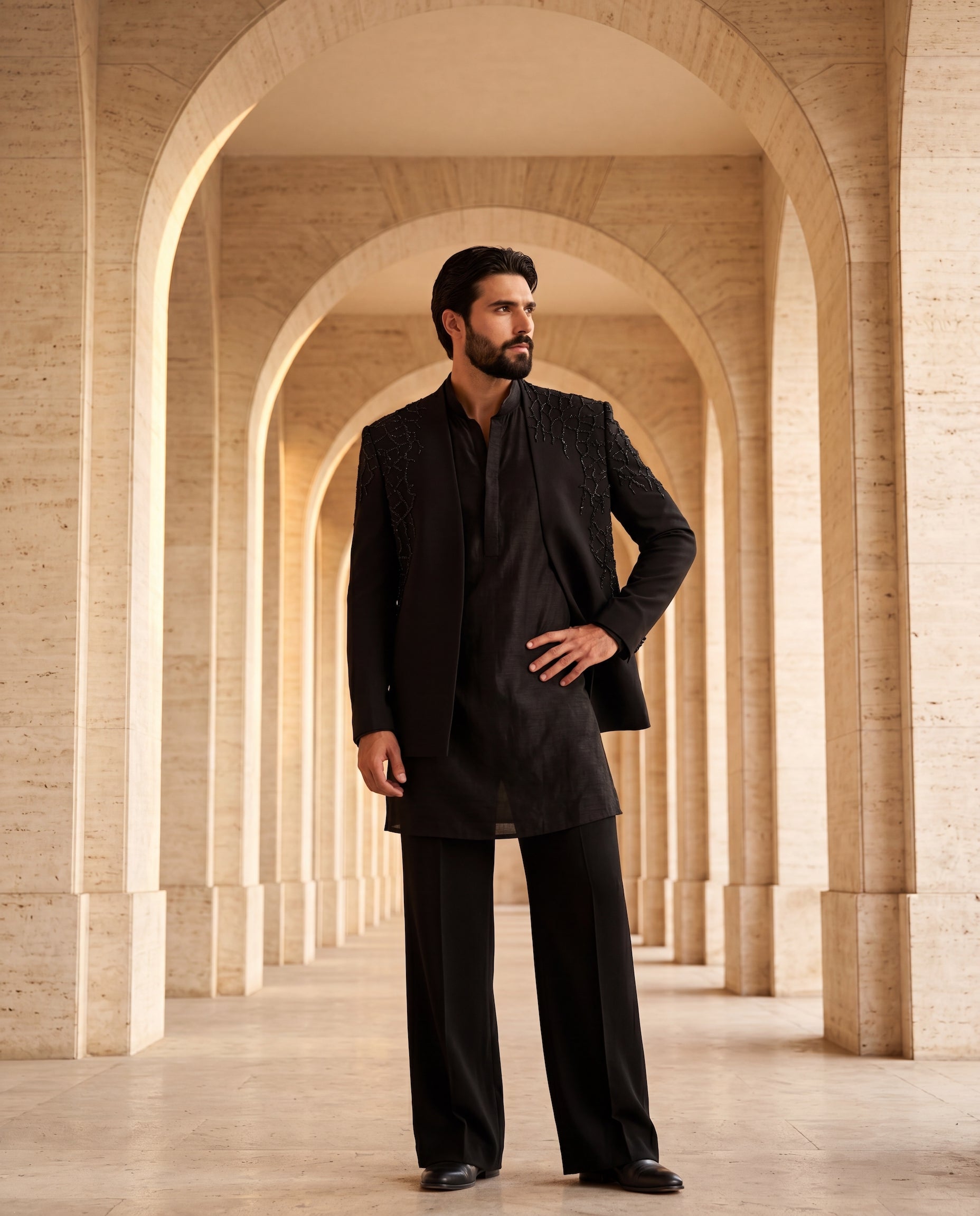Textured knit Indo-Western jacket with tonal detailing, paired with a raw silk kurta and matching knit pants.