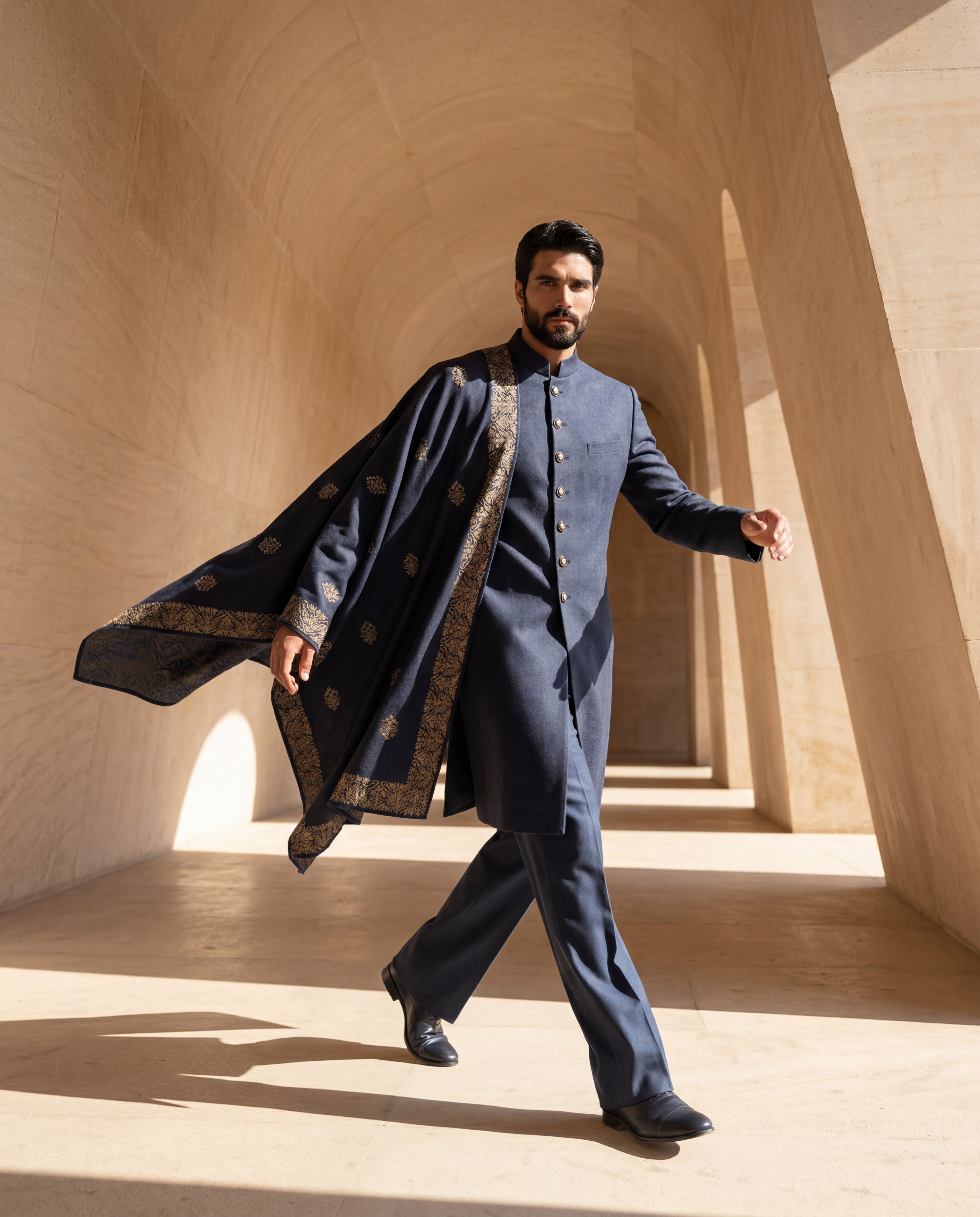 Navy blue Pashmina sherwani featuring contrast buttons along the front, paired with matching pashmina pants and a pashmina stole embellished with a hand-embroidered border & motifs all over.