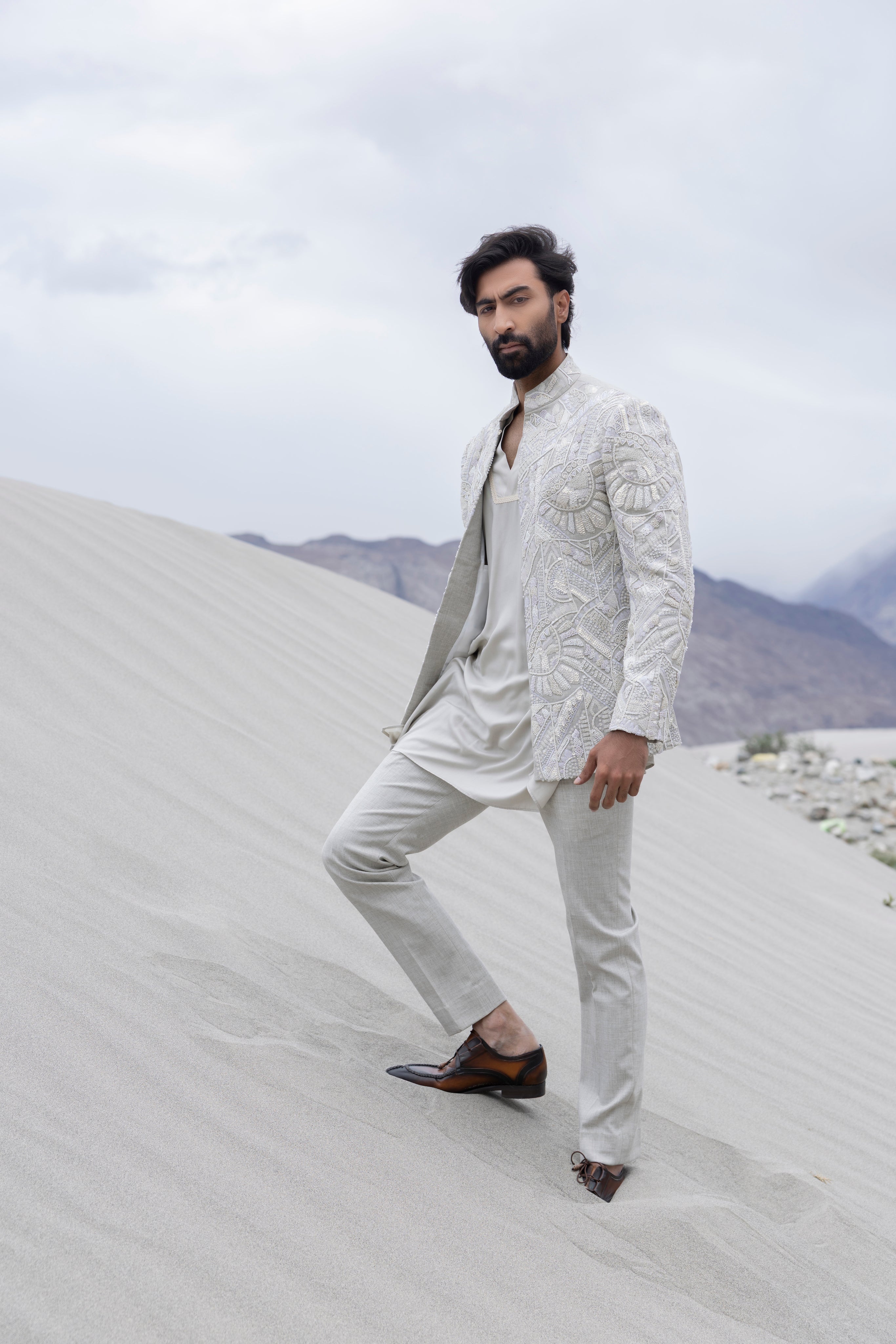 Grey font open hand-embroidered  indowestern jacket paired with a v-neck short  kurta and pants.
