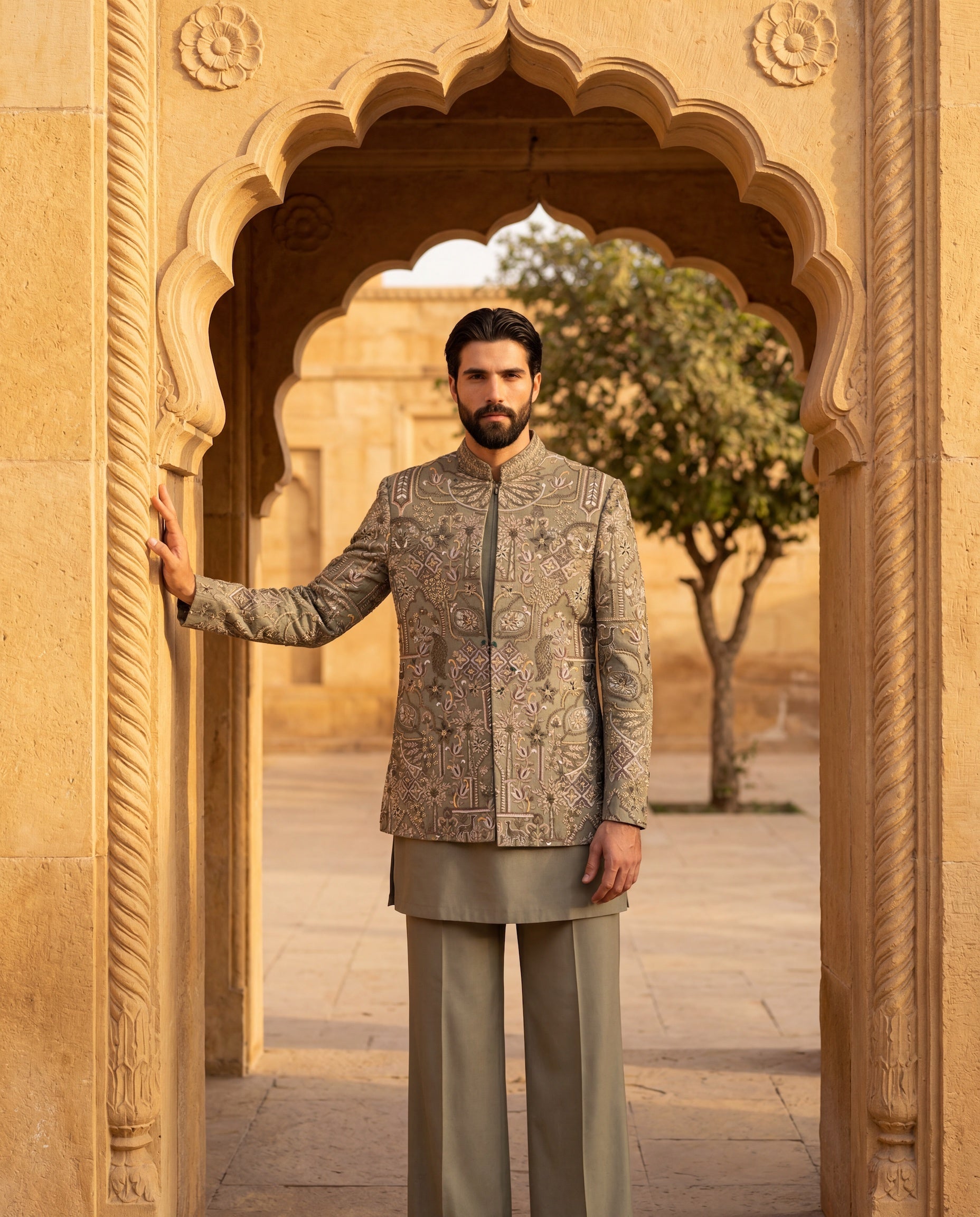 Sage green Twill knit Indo-Western jacket with multi-coloured embroidery detailing, paired with a cotton modal kurta and matching twill knit pants.