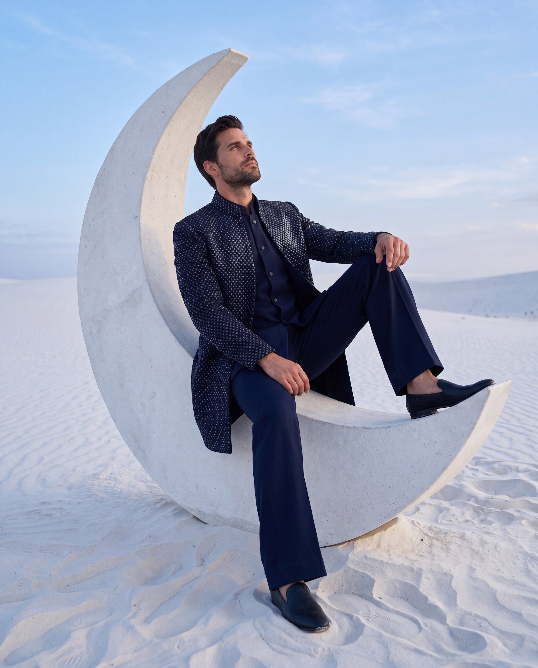 Navy blue crepe Indo-Western jacket with monotone embroidery paired with a matka silk waistcoat and knit pants.