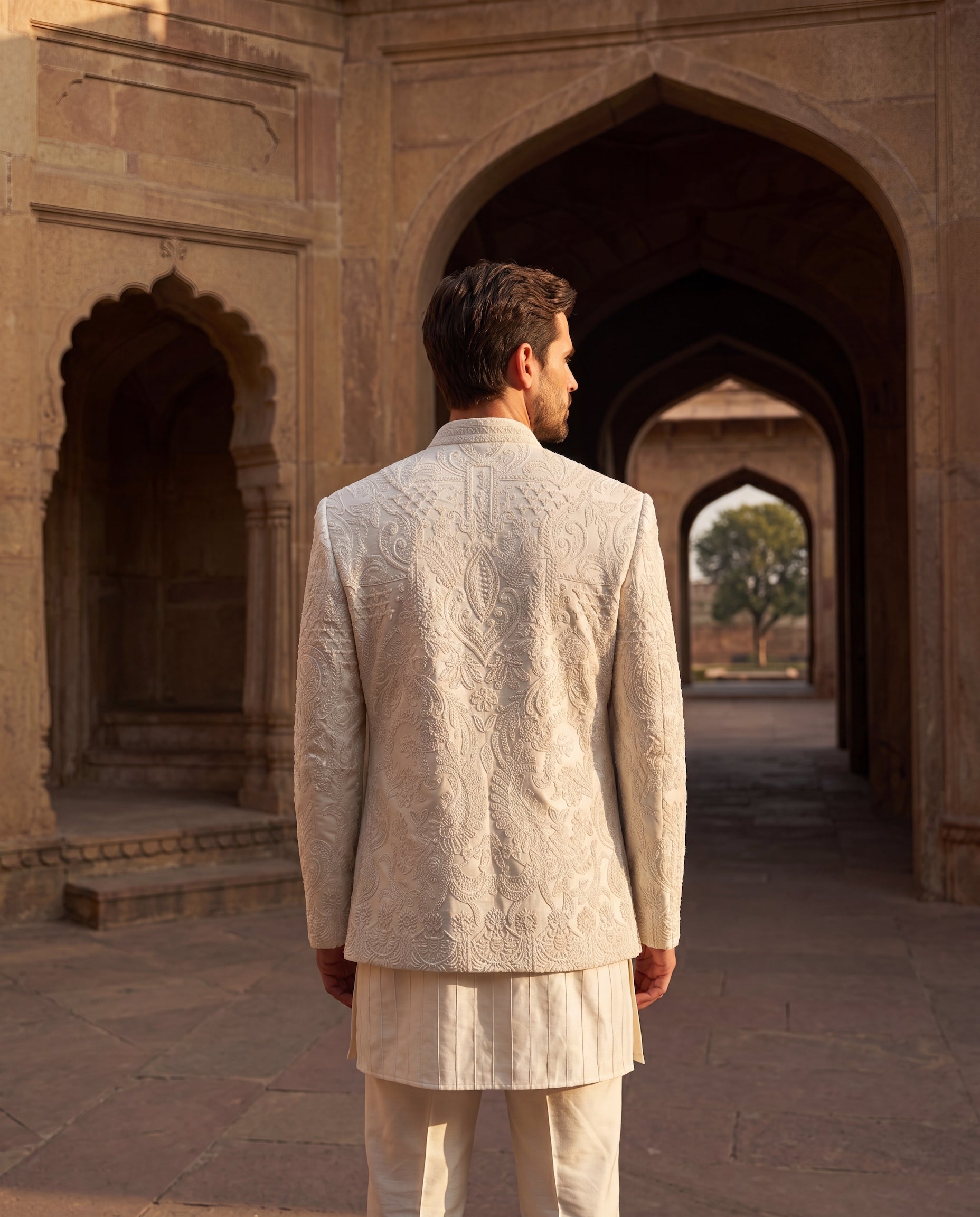 Linen rayon silk Indo-Western jacket with monotone embroidery detailing, paired with a kurta with pintucks detailing and matching palazzo.