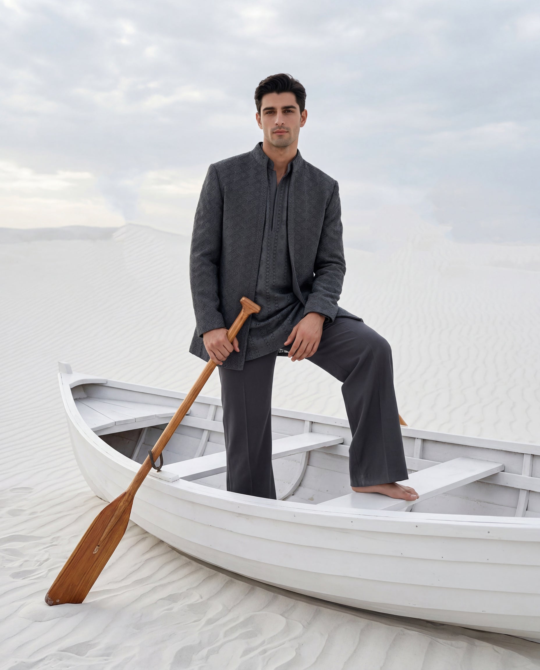 Dark grey crochet Indo-Western jacket with embroidery detailing, paired with a matching crochet kurta and knit pants.