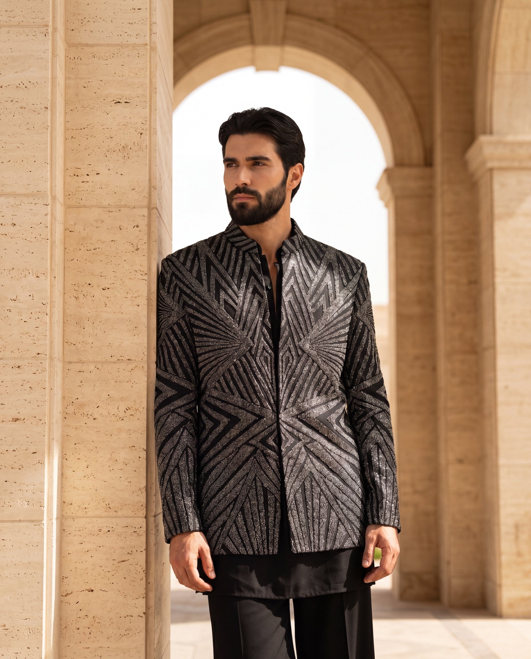 Black knit Indo-Western jacket with metallic embroidery, paired with a cotton modal kurta and matching palazzo.