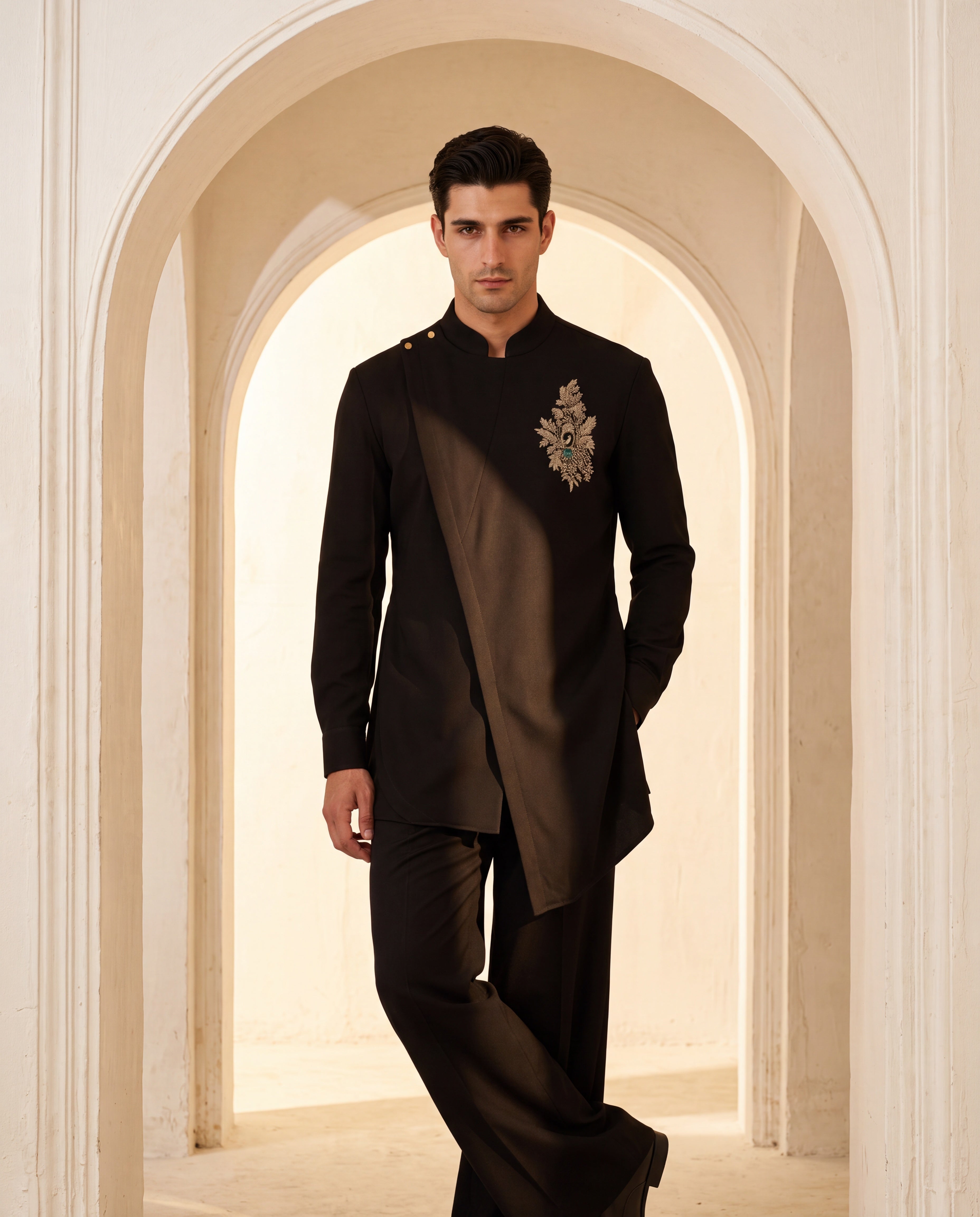 Black knit kurta with gold brooch with embroidery & asymmetric cut detailing, paired with matching knit palazzo.