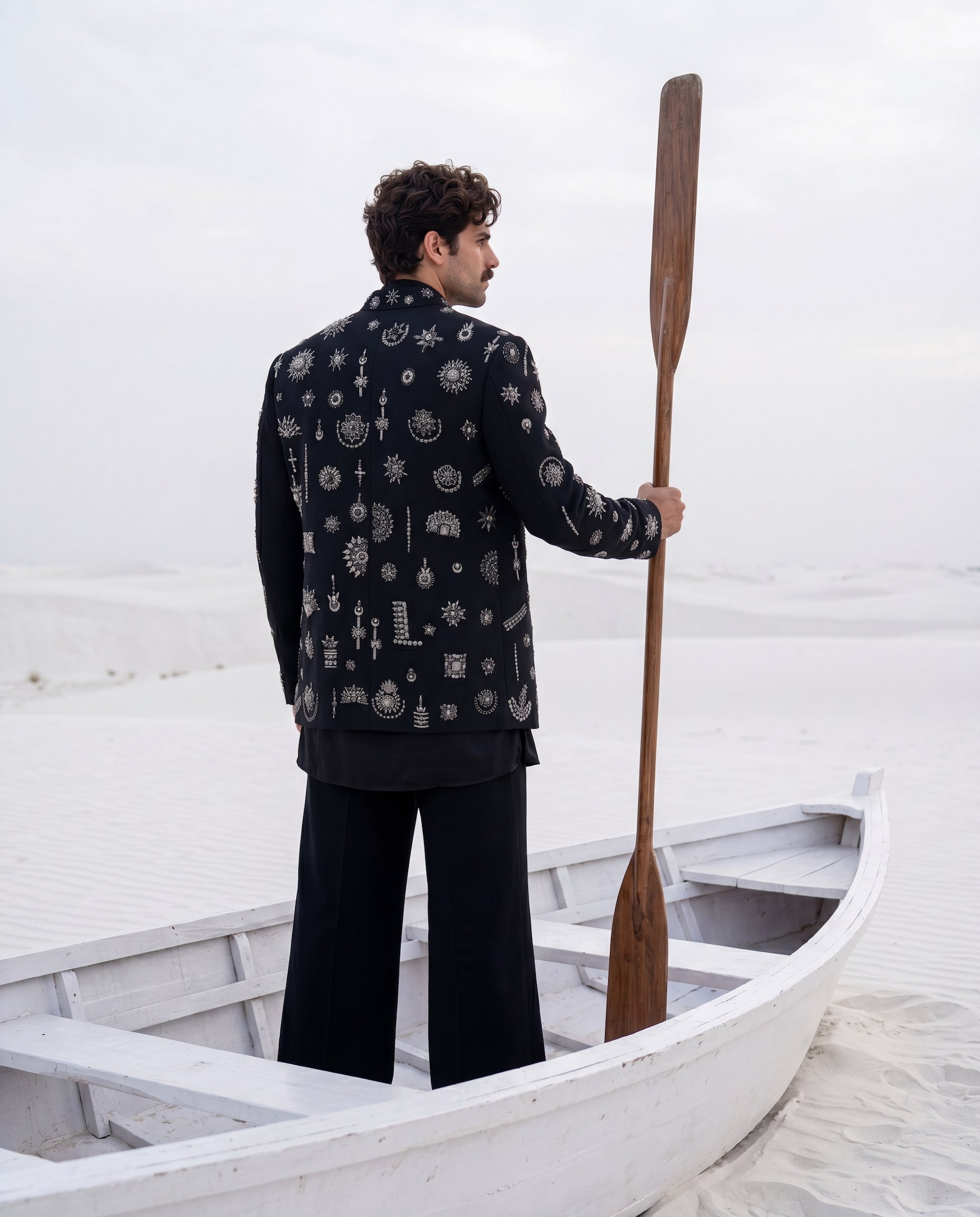 Black herringbone knit Indo-Western jacket with metallic motifs embroidery detailing, paired with a cowl kurta and matching palazzo.