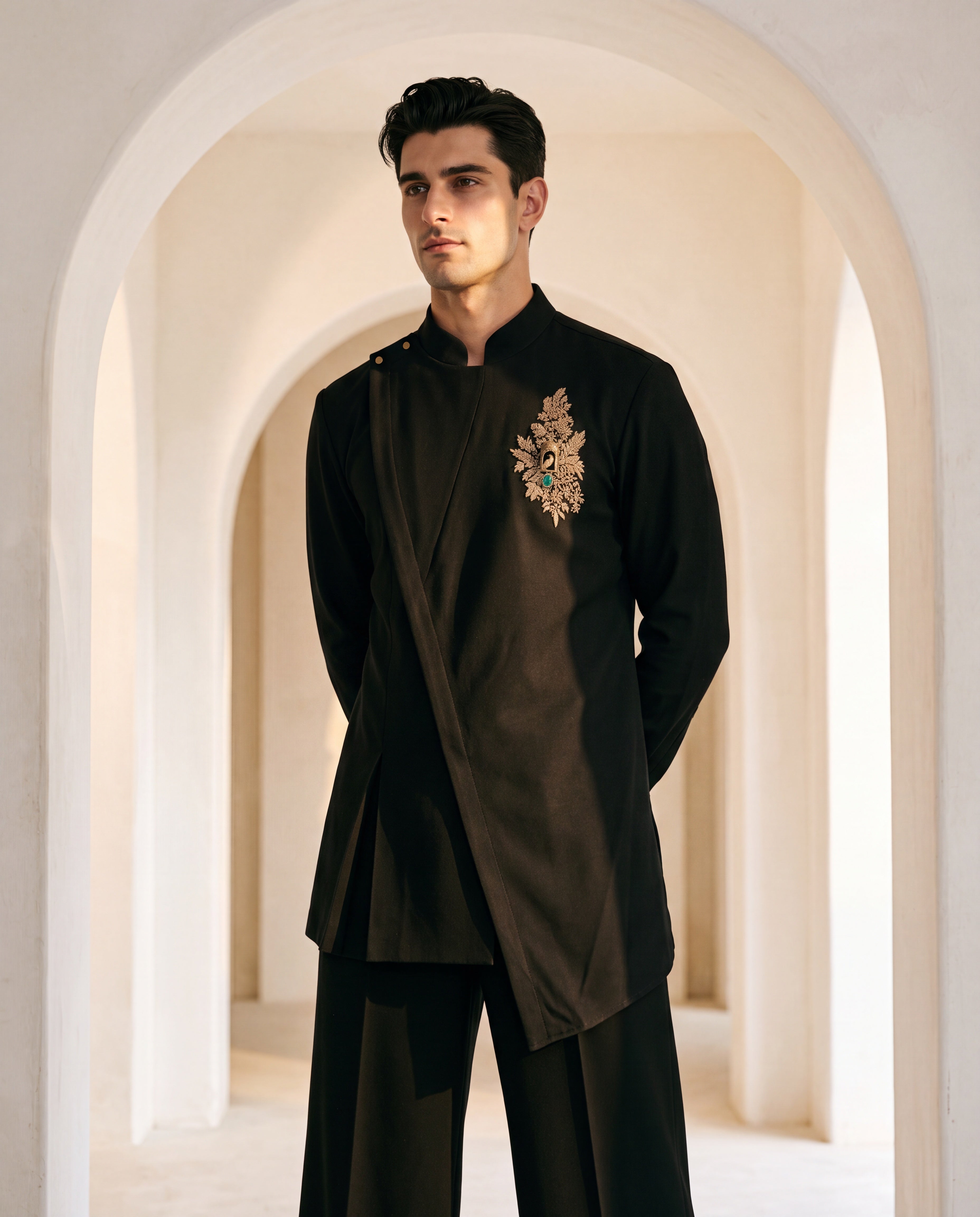 Black knit kurta with gold brooch with embroidery & asymmetric cut detailing, paired with matching knit palazzo.