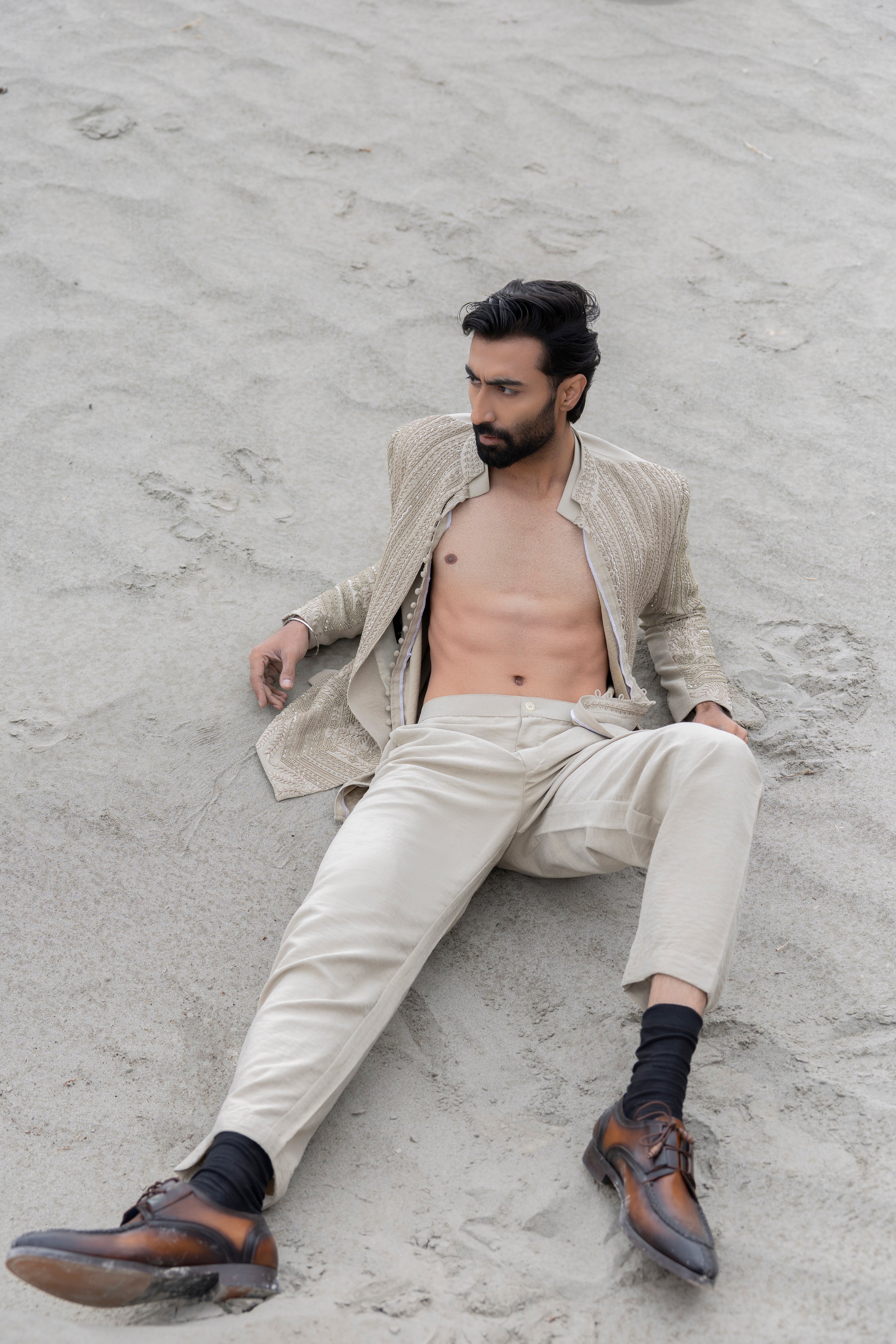 Beige front open short indowestern jacket with monotone hand-embroidery paired with a short loop button  kurta and pants.