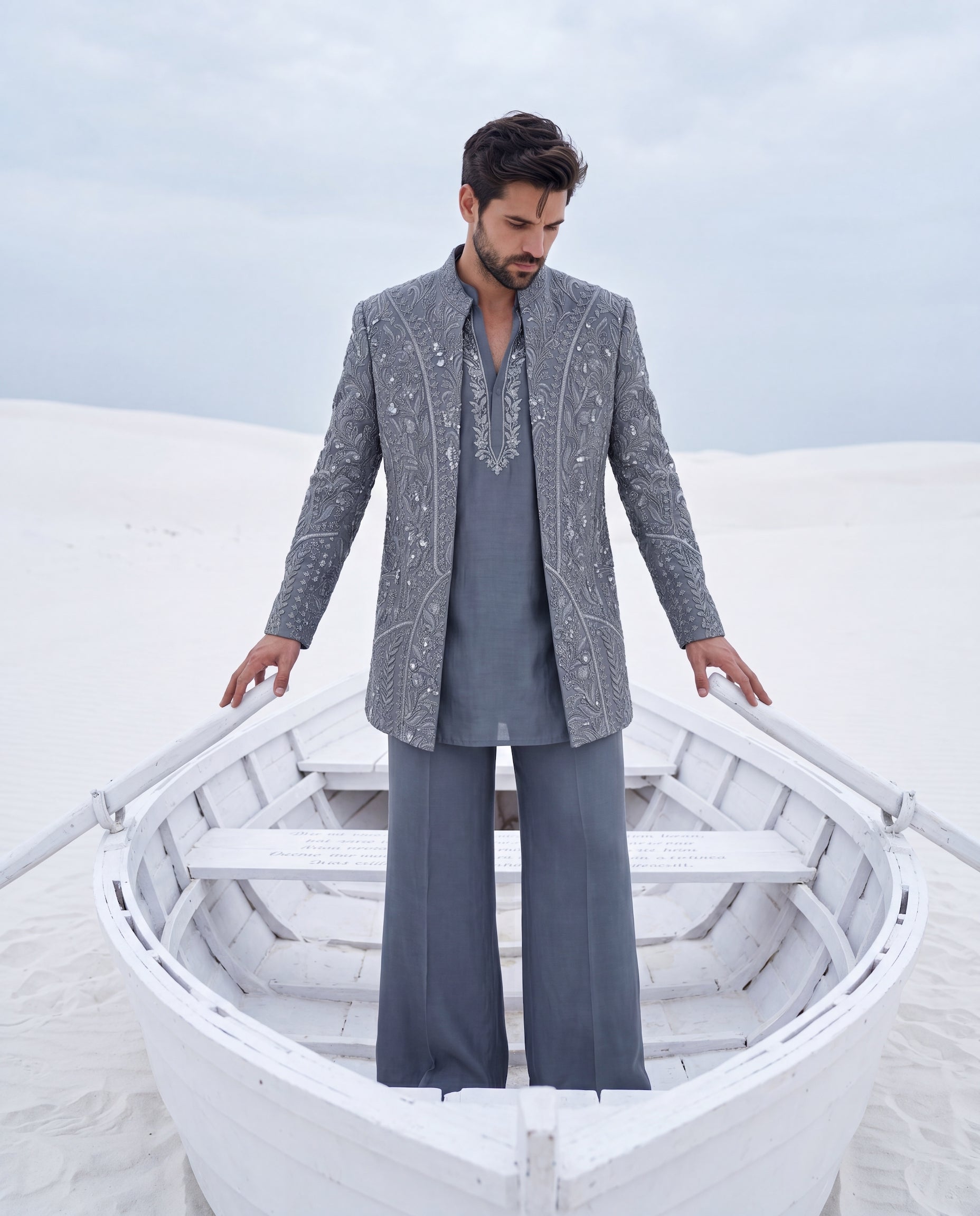 Grey textured knit Indo-Western jacket with monotone embroidery, paired with a cotton modal kurta and matching textured knit pants.