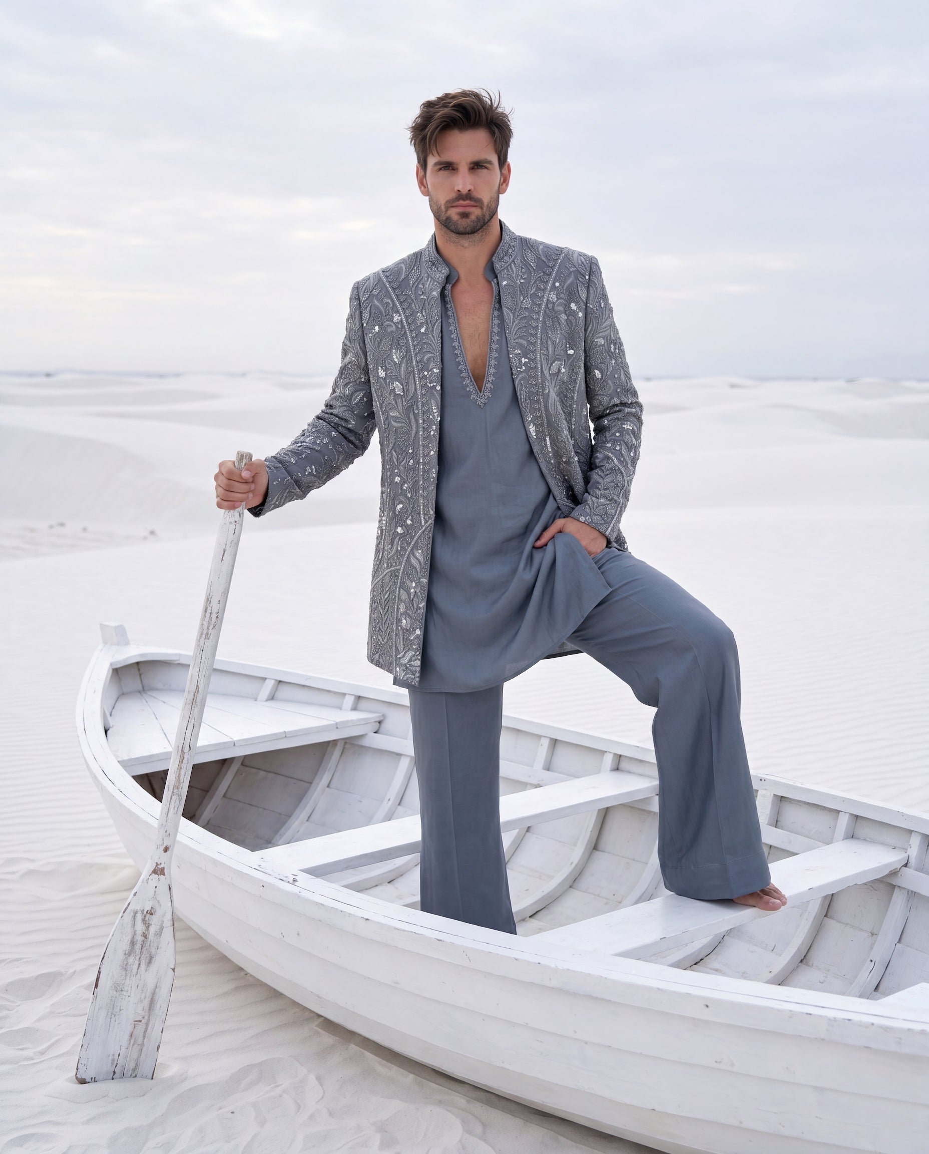 Grey textured knit Indo-Western jacket with monotone embroidery, paired with a cotton modal kurta and matching textured knit pants.