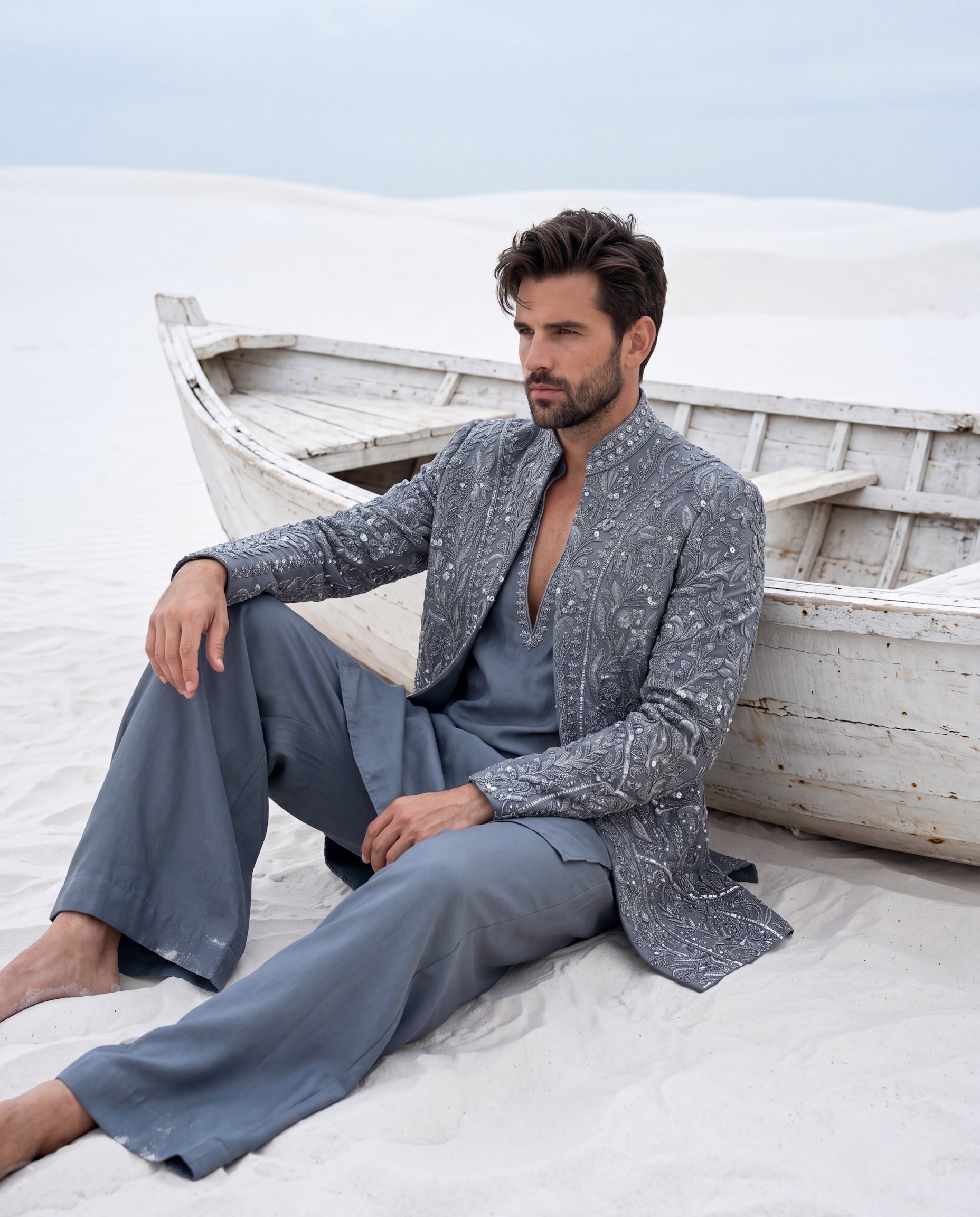 Grey textured knit Indo-Western jacket with monotone embroidery, paired with a cotton modal kurta and matching textured knit pants.
