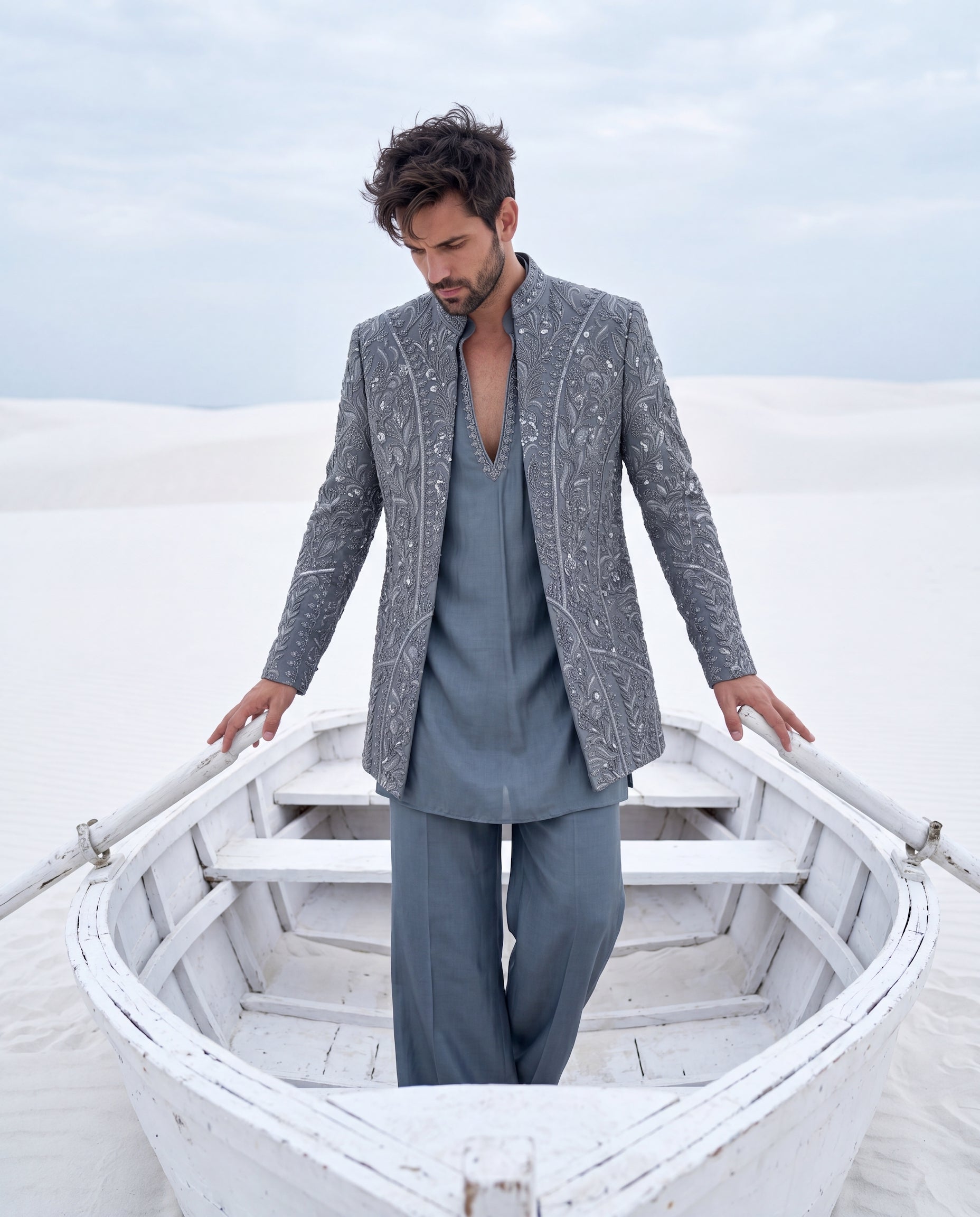 Grey textured knit Indo-Western jacket with monotone embroidery, paired with a cotton modal kurta and matching textured knit pants.