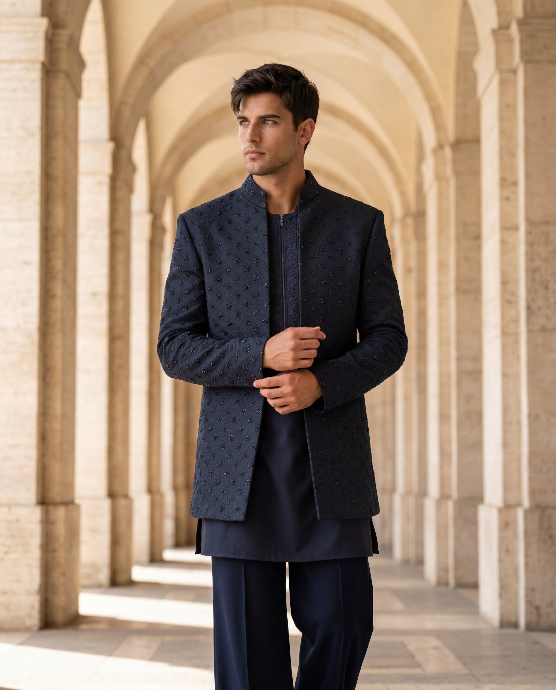 Navy blue twill knit Indo-Western jacket with monotone embroidery, paired with a knit kurta and matching twill knit pants.