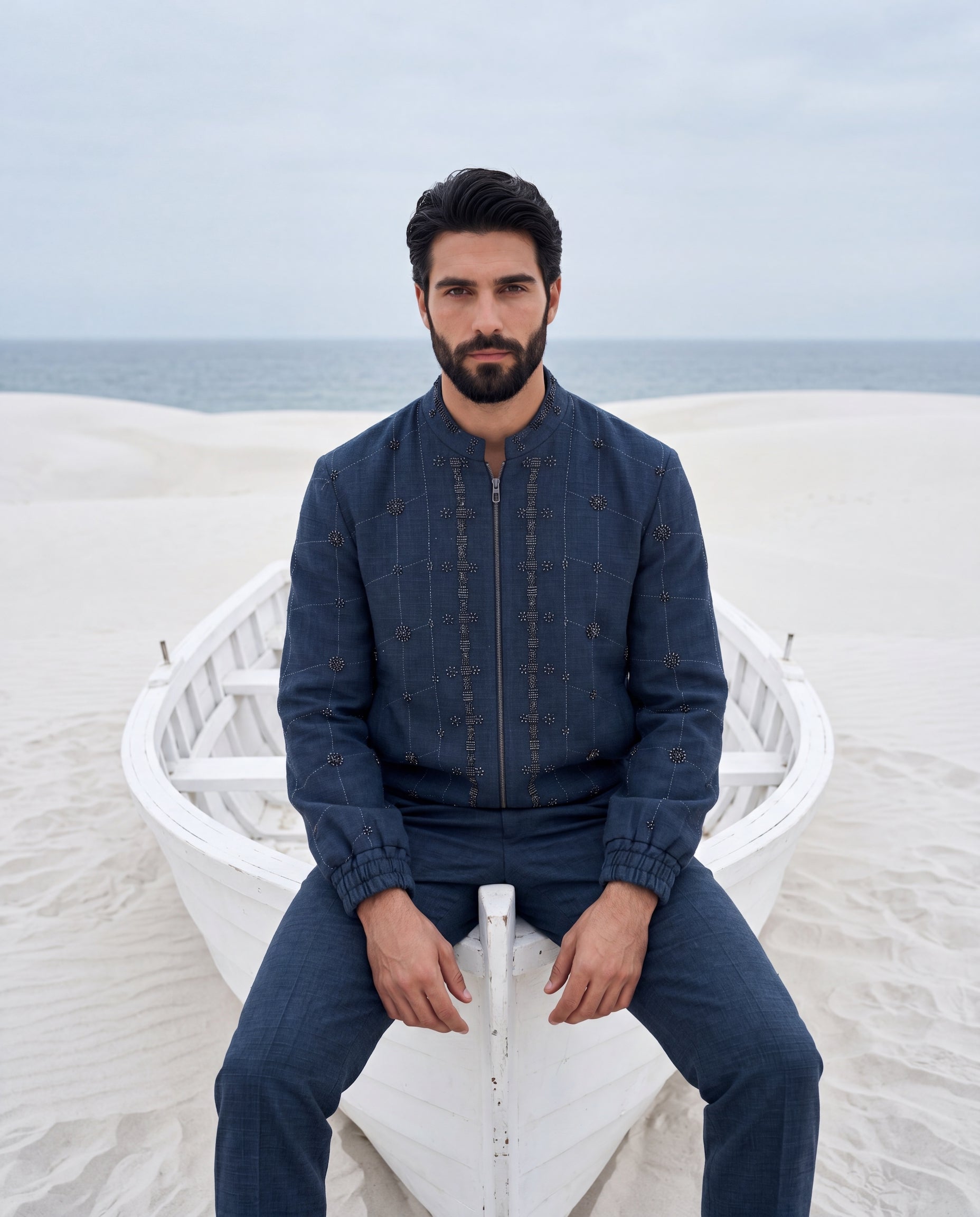 Textured knit bomber jacket with metallic embroidery, paired with matching textured knit pants.