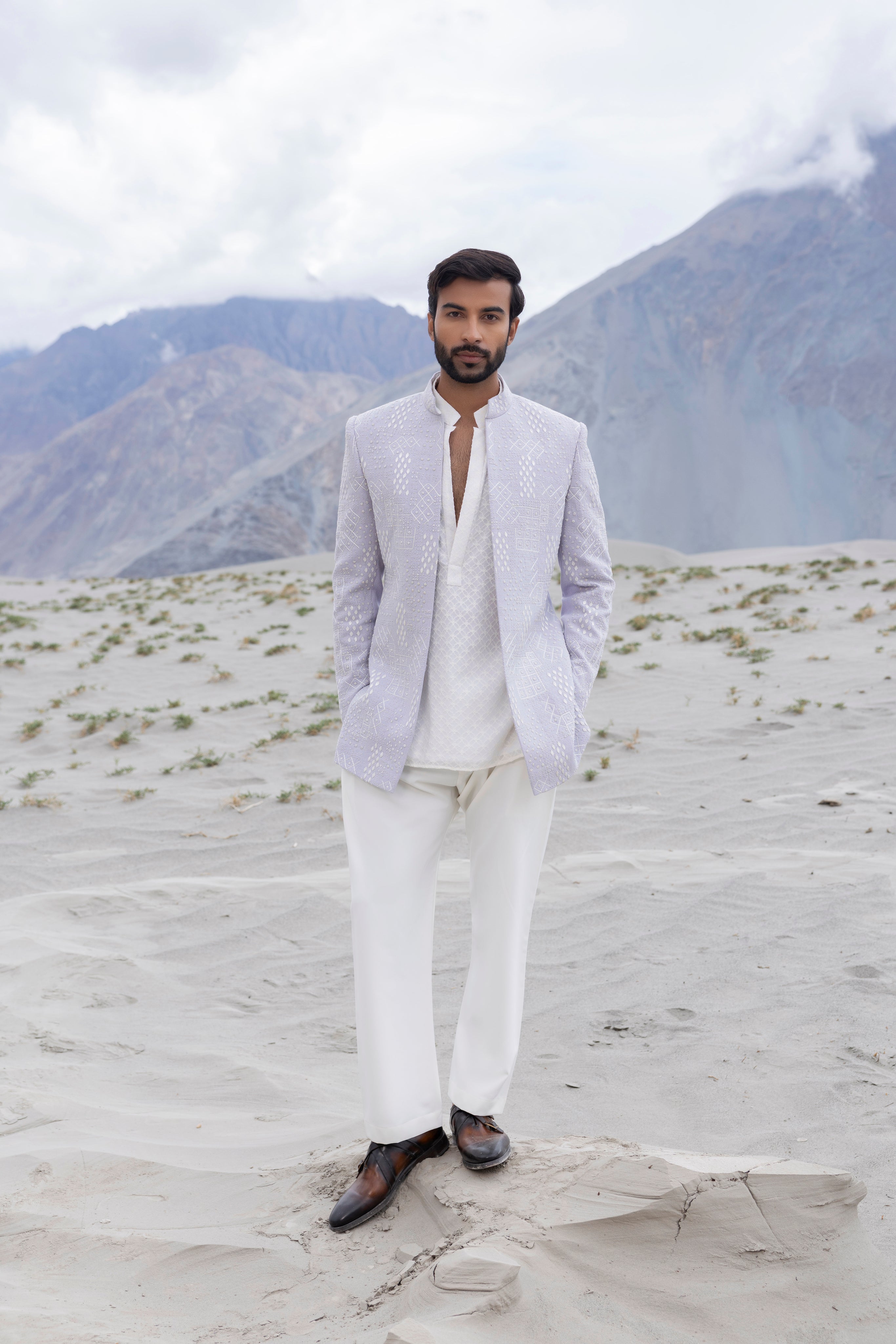 Lilac front open short indowestern jacket ivory hand-embroidery paired with an ivory embroidered georgette short kurta  and pants.