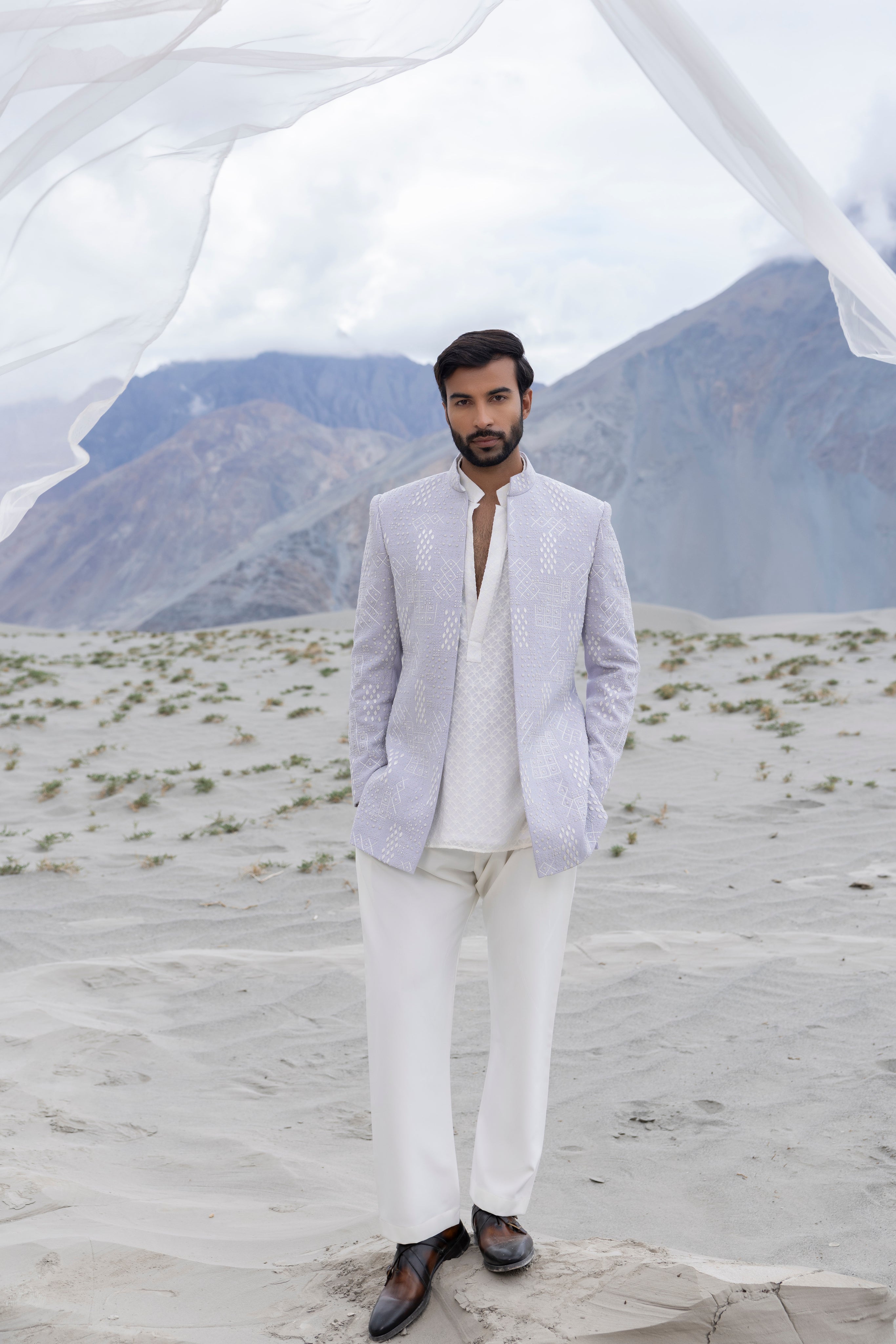 Lilac front open short indowestern jacket ivory hand-embroidery paired with an ivory embroidered georgette short kurta  and pants.