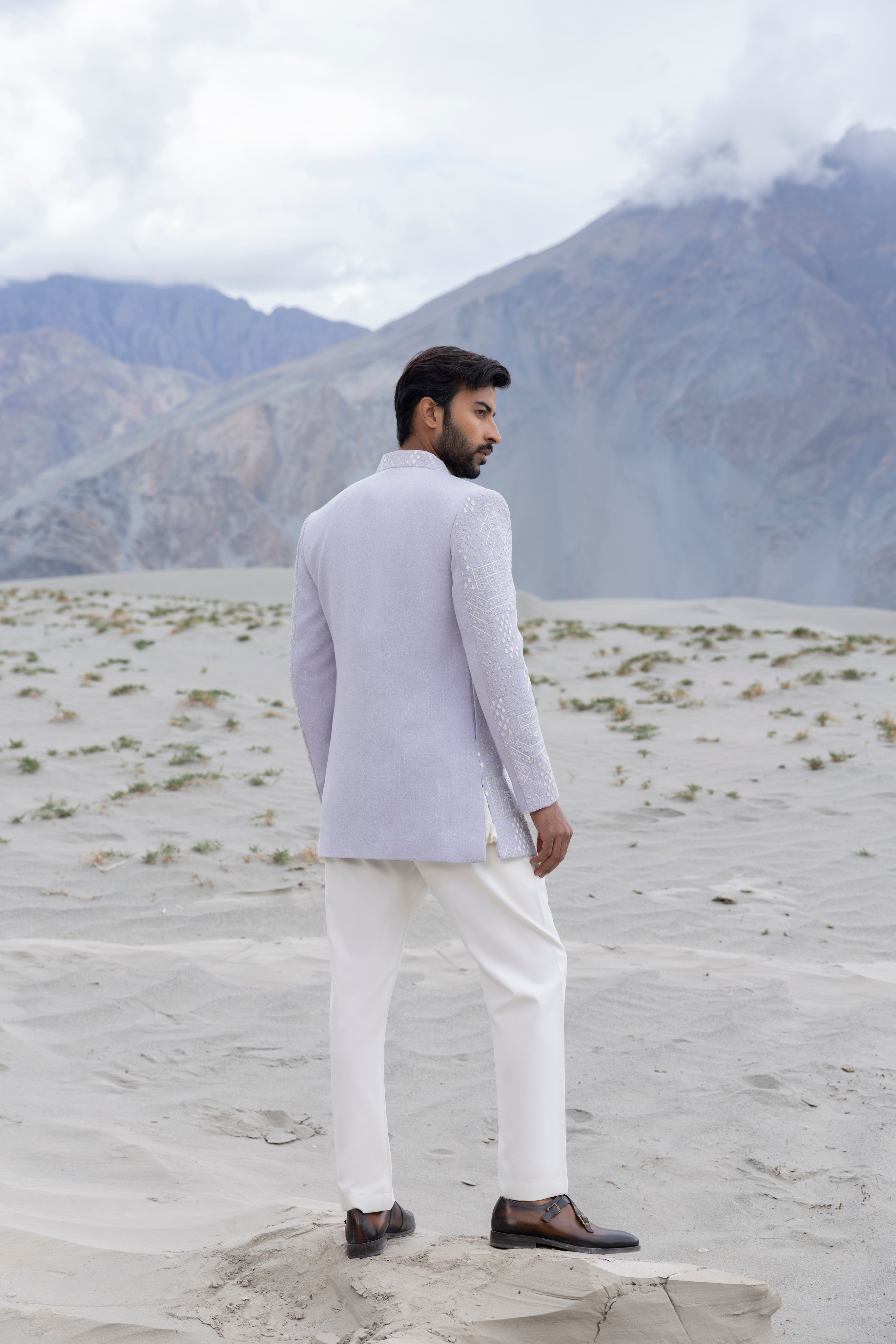 Lilac front open short indowestern jacket ivory hand-embroidery paired with an ivory embroidered georgette short kurta  and pants.