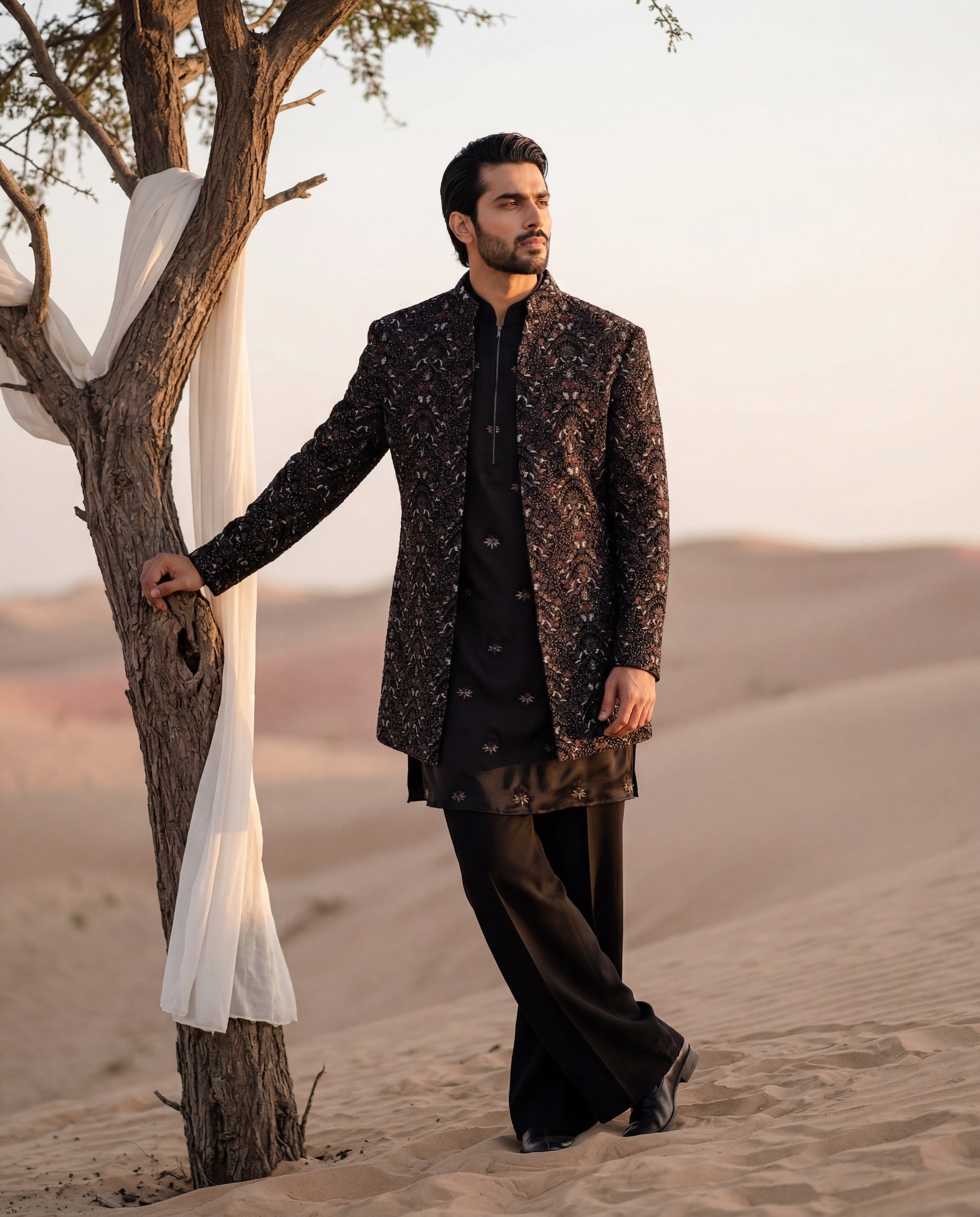 Black velvet Indo-Western jacket with intricate multi-coloured hand-embroidered, paired with an embroidered knit kurta and matching palazzo.