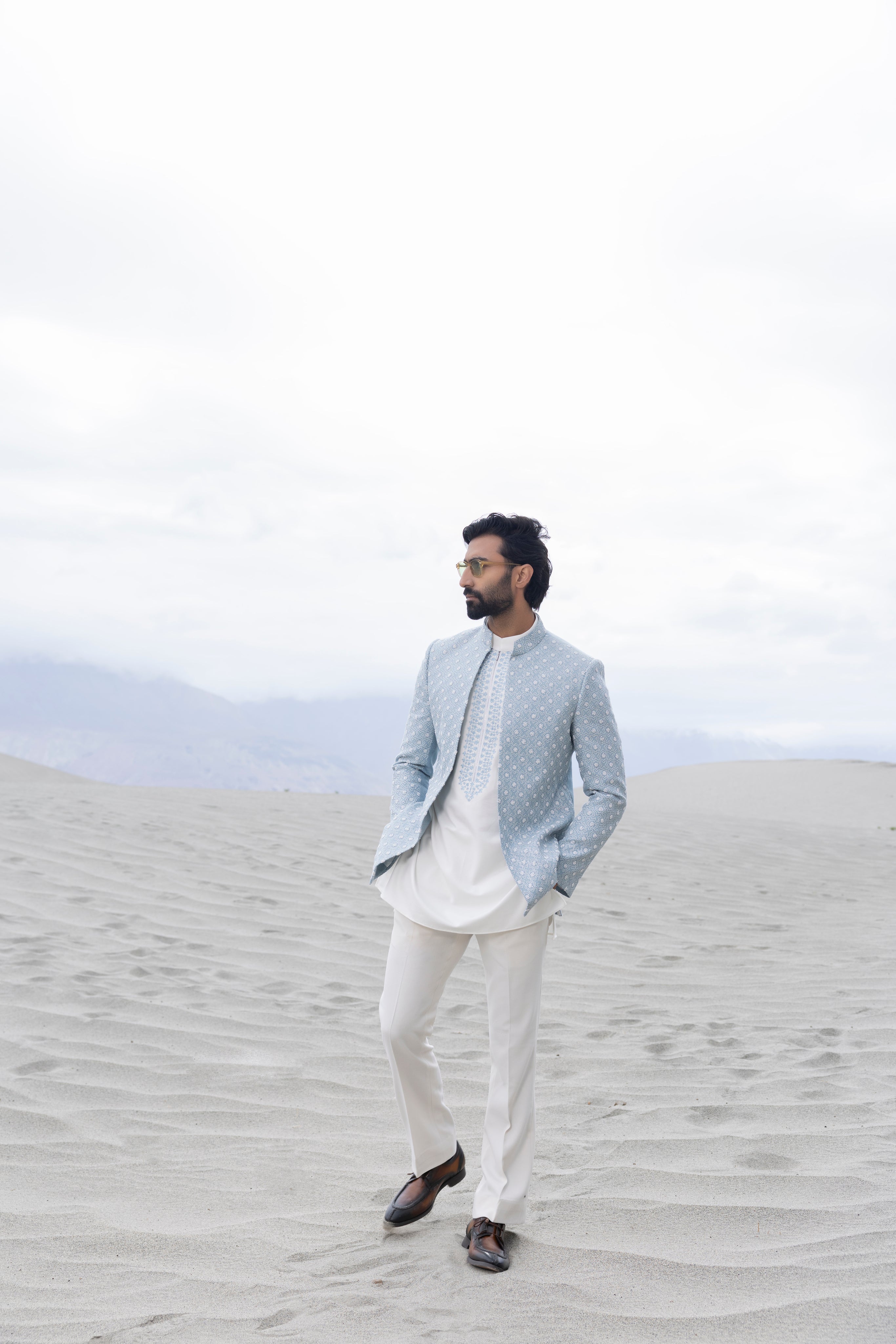 Sky Blue front open short indowestern jacket ivory hand-embroidery paired with an ivory embroidered  short kurta  and pants.