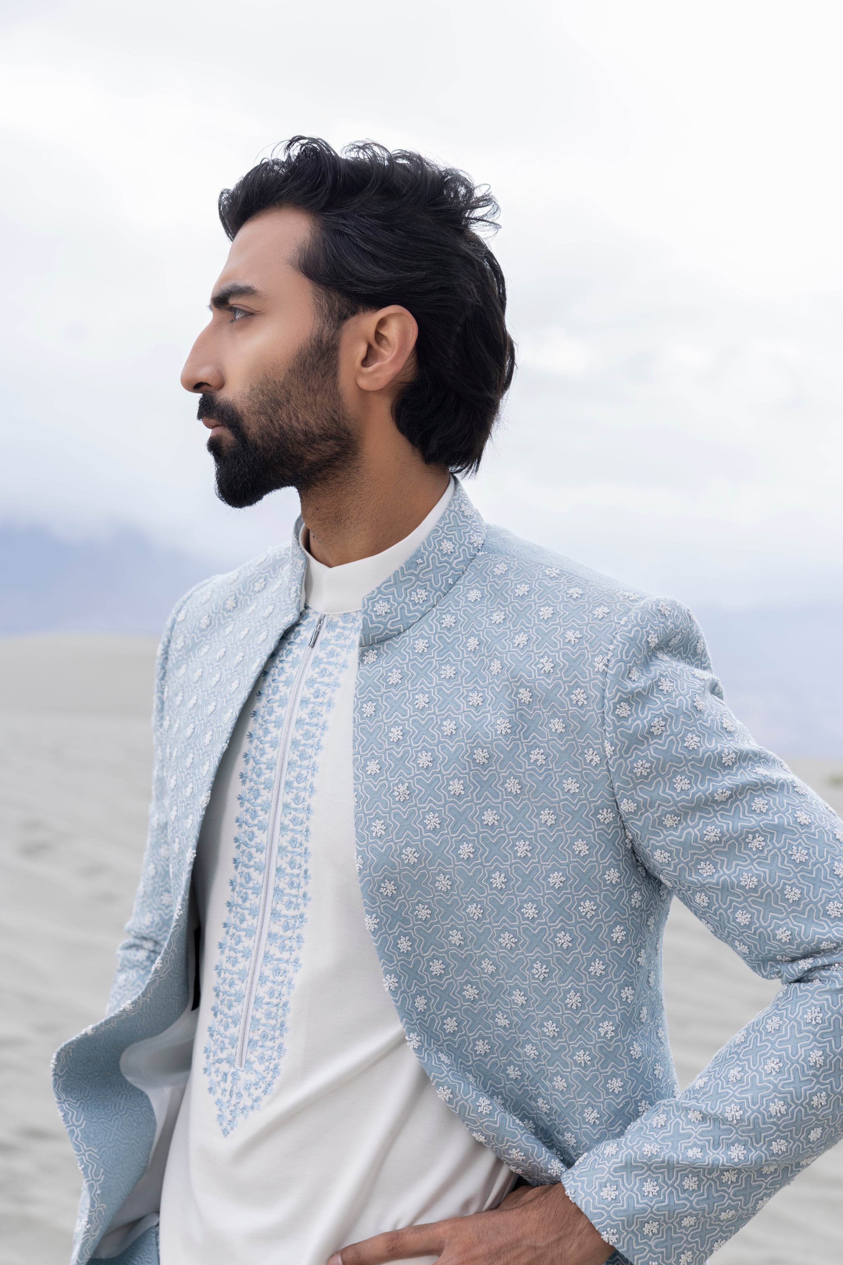 Sky Blue front open short indowestern jacket ivory hand-embroidery paired with an ivory embroidered  short kurta  and pants.