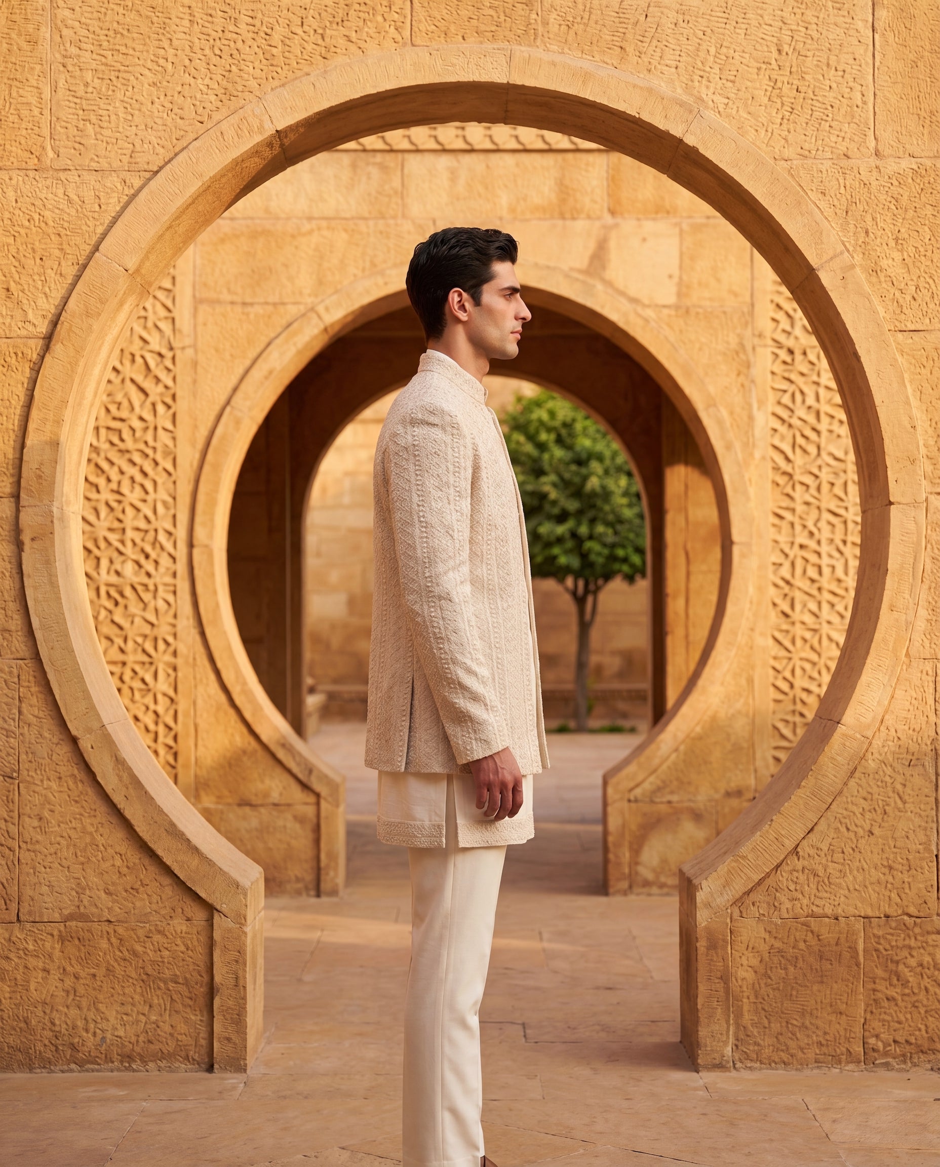 Crochet Indo-Western jacket embellished with hand-embroidered detailing, paired with a Monga silk kurta with crochet borders and knit pants.