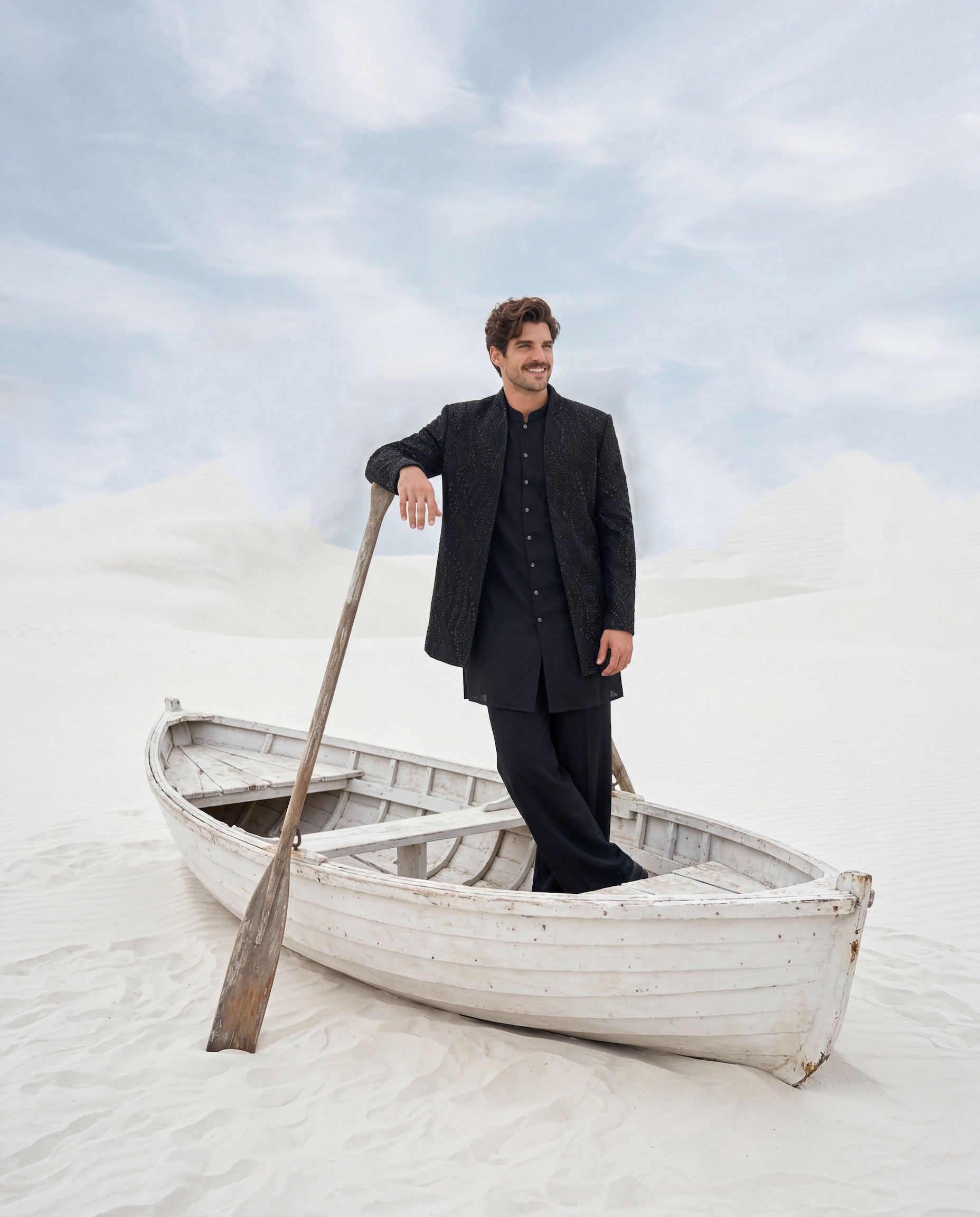 Black crepe Indo-Western jacket with monotone embroidery, paired with a matching crepe kurta and knit pants.