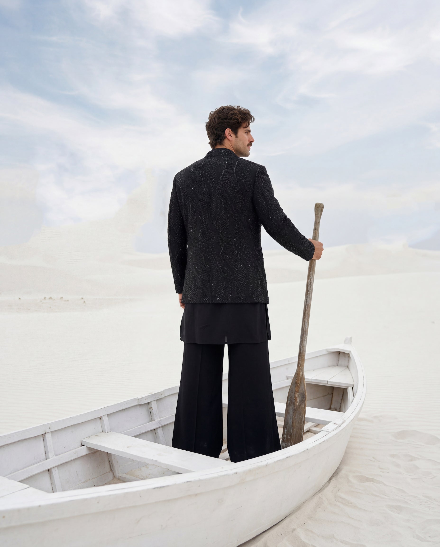 Black crepe Indo-Western jacket with monotone embroidery, paired with a matching crepe kurta and knit pants.