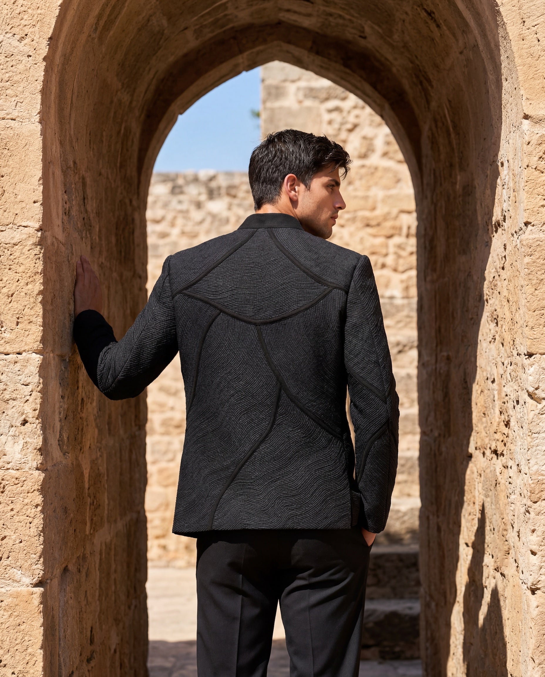 Black knit bomber jacket with monotone dori embroidery detailing, paired with matching knit pants.