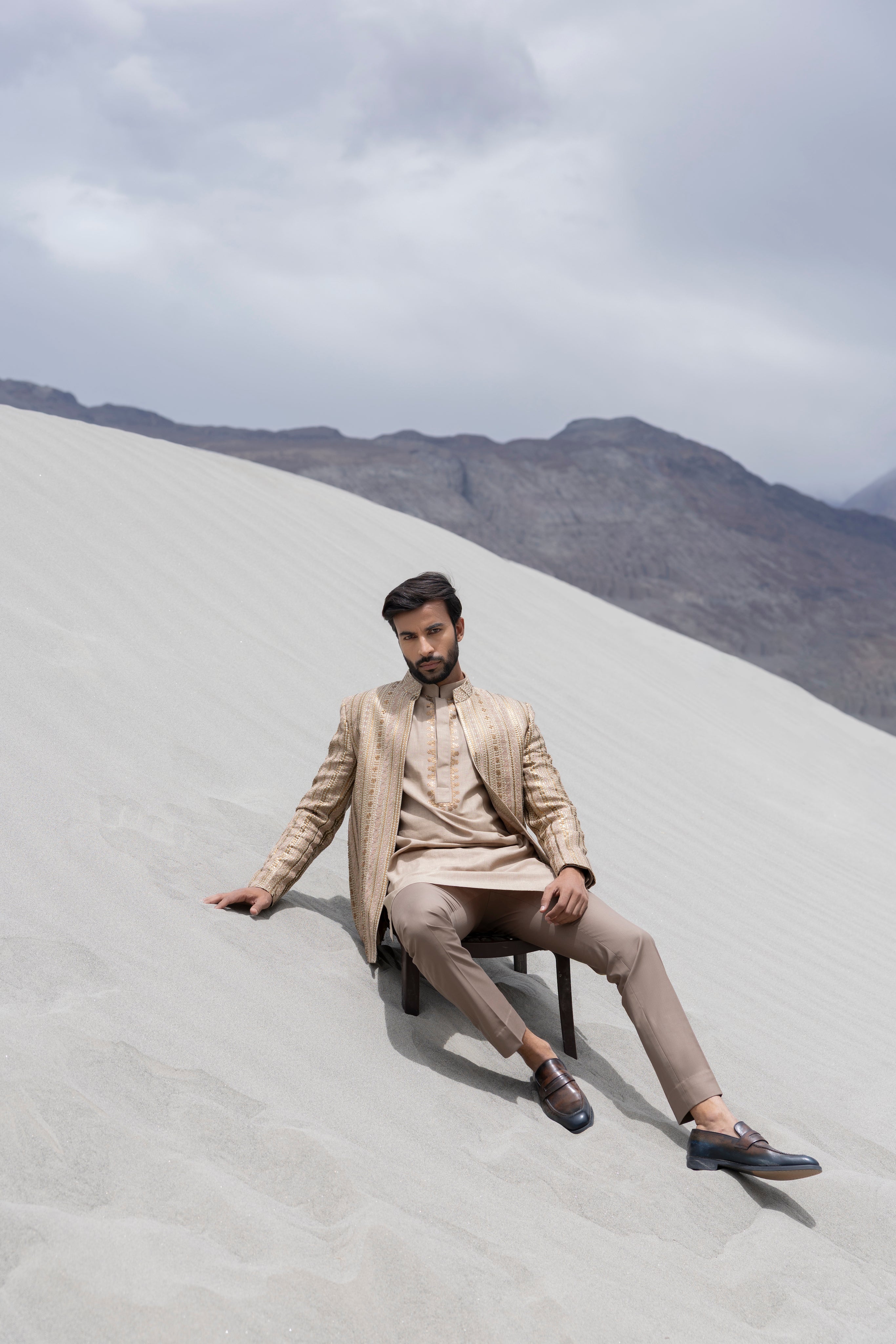 Beige front open silk jaquard indowestern jacket with monotone hand-embroidery paired with an embroidered kurta and pants.